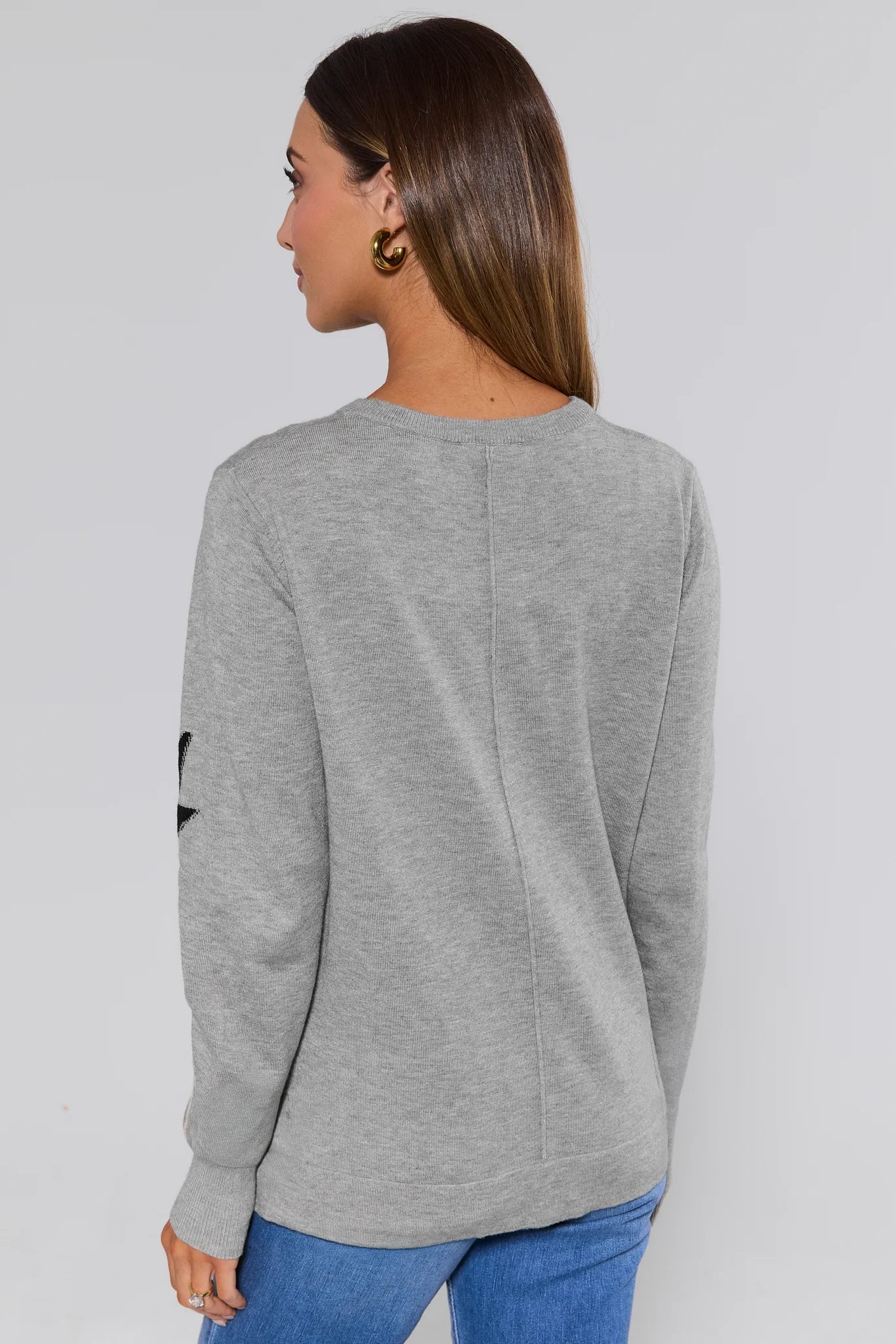 Woman wearing a gray sweater with colorful lightning bolt patterns on a plain background Lightning Bolt Sweater