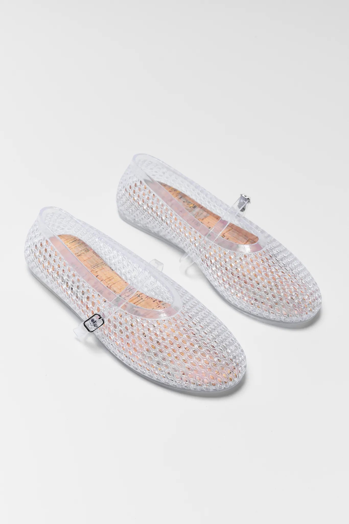 Pair of Sally Clear Jelly Flats on a light gray white background