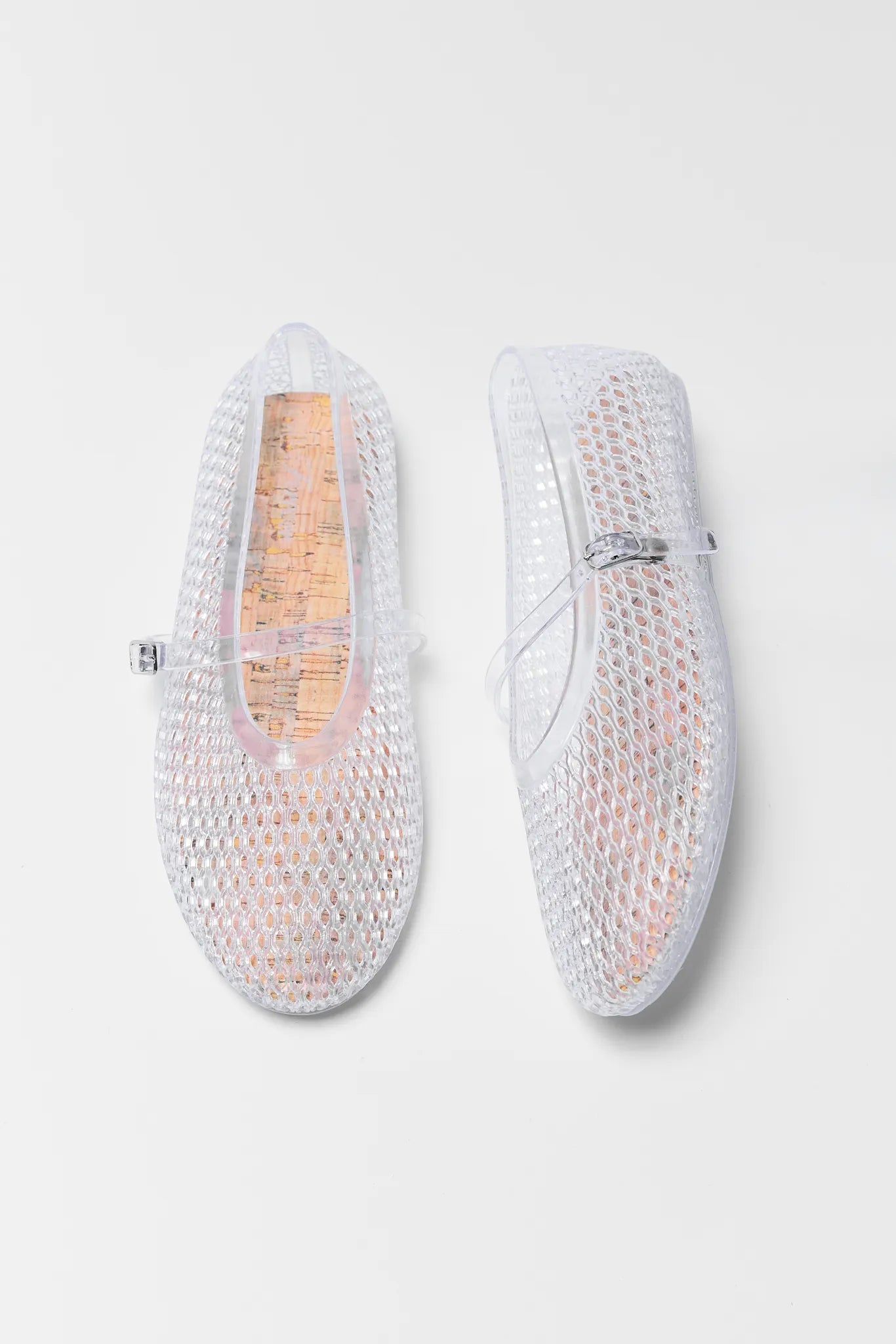 Pair of Sally Clear Jelly Flats on a light gray background