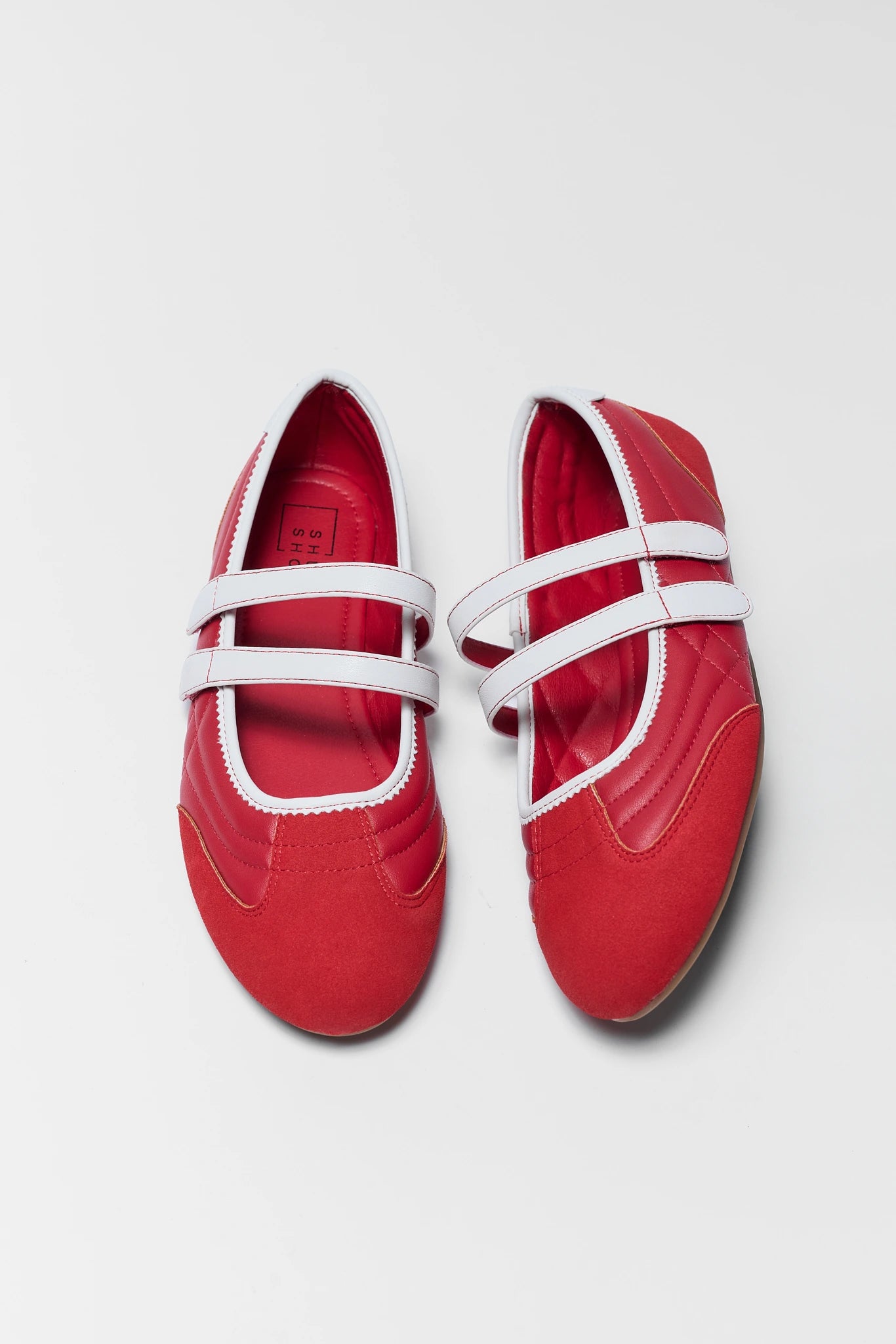 two red flat sneakers