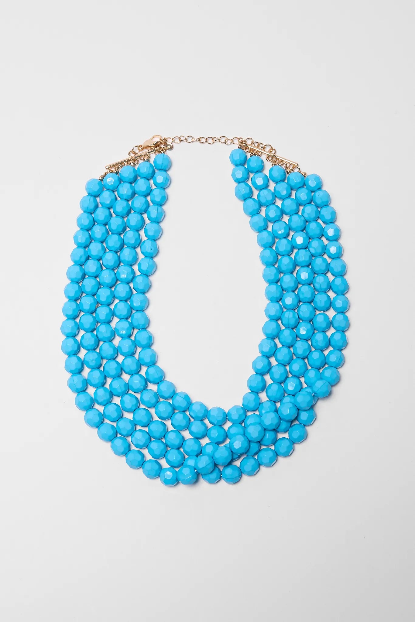 Turquoise beaded necklace on a light gray background