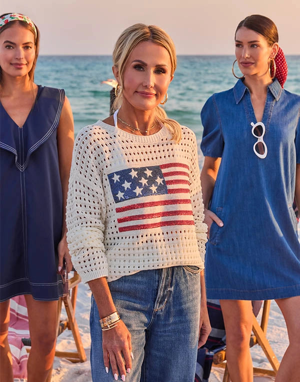 woman wearing flag sweater on beach campfire nav