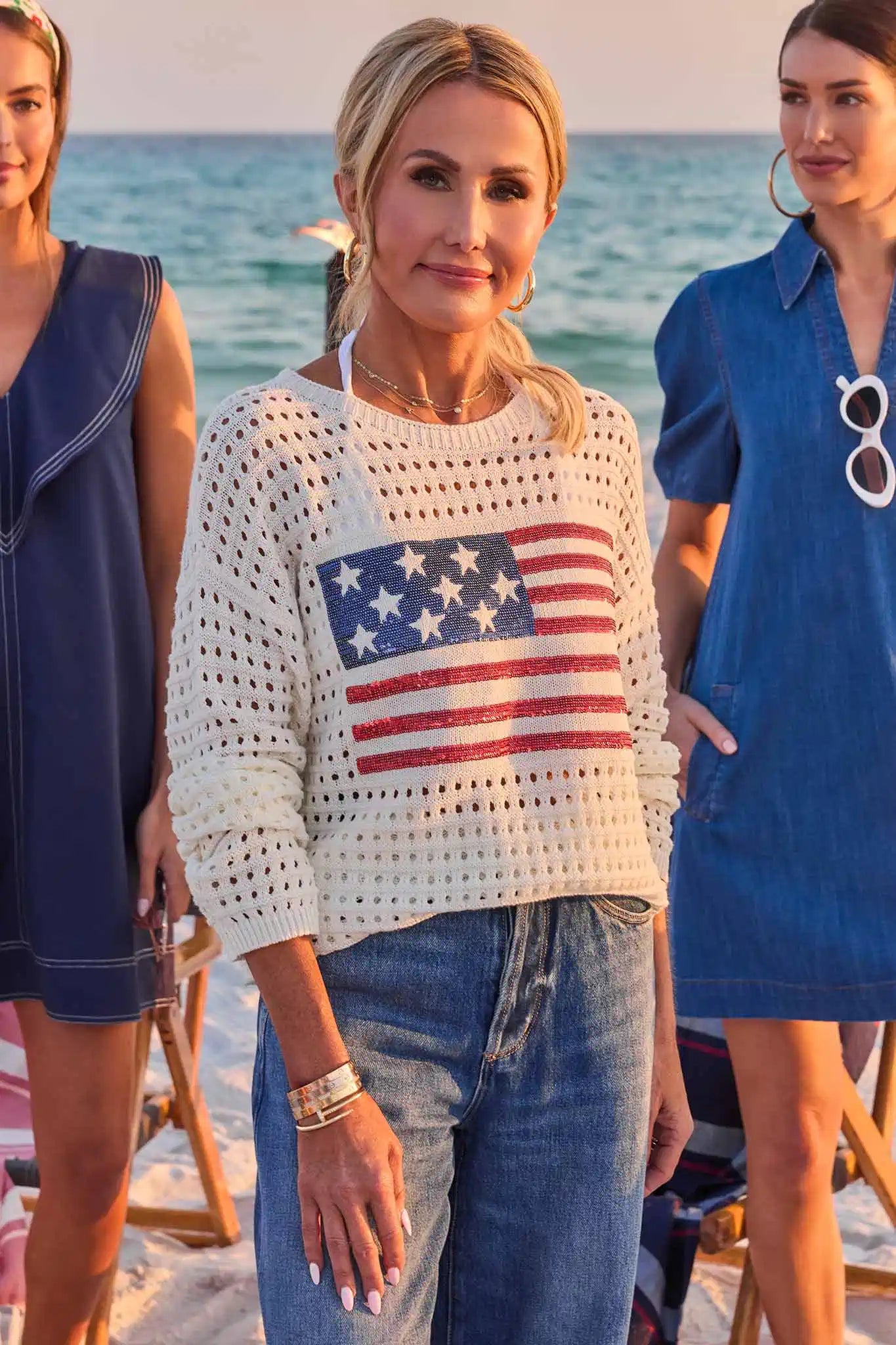 woman wearing star sweater on beach