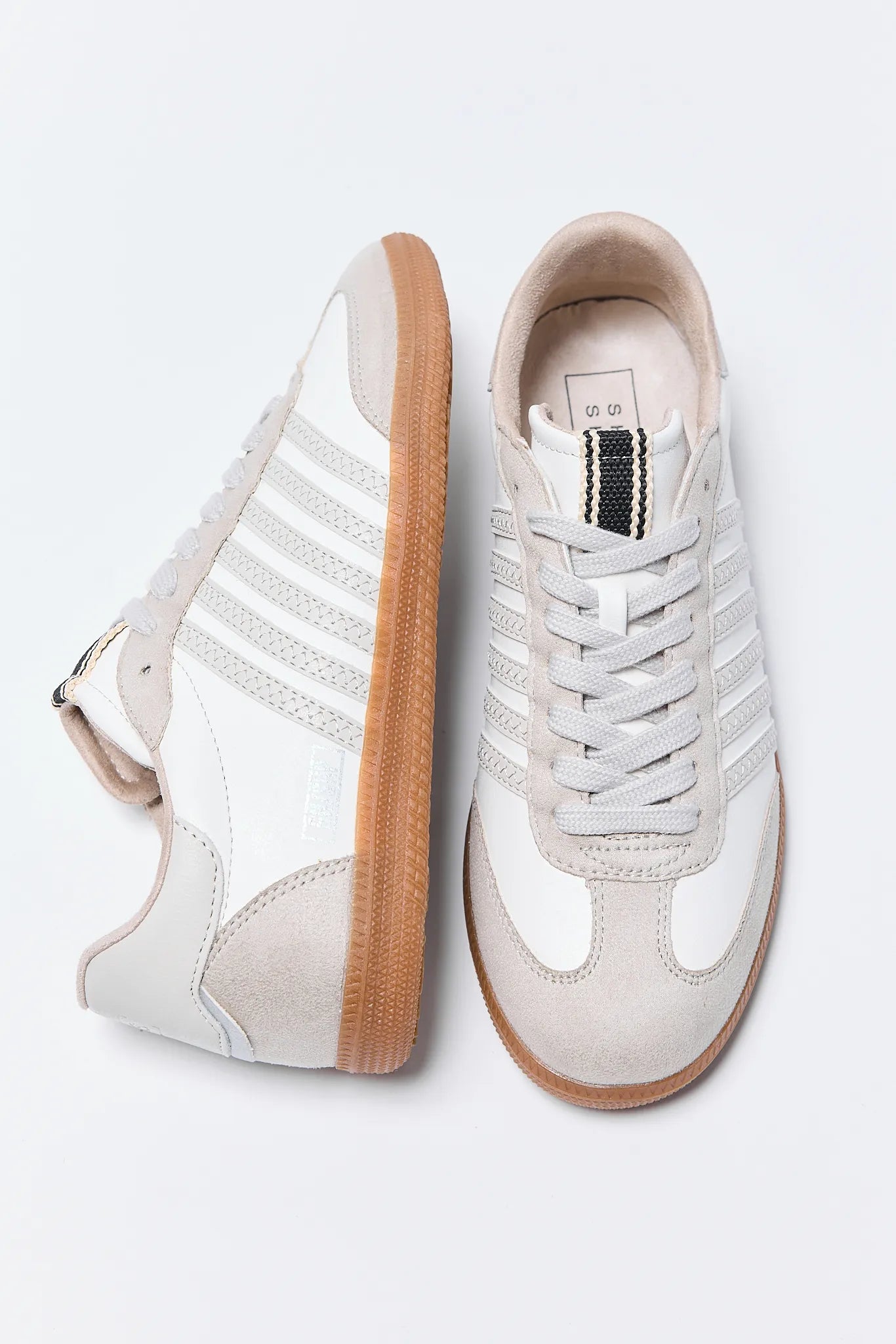 White Stevie Sneakers with brown soles on a white background