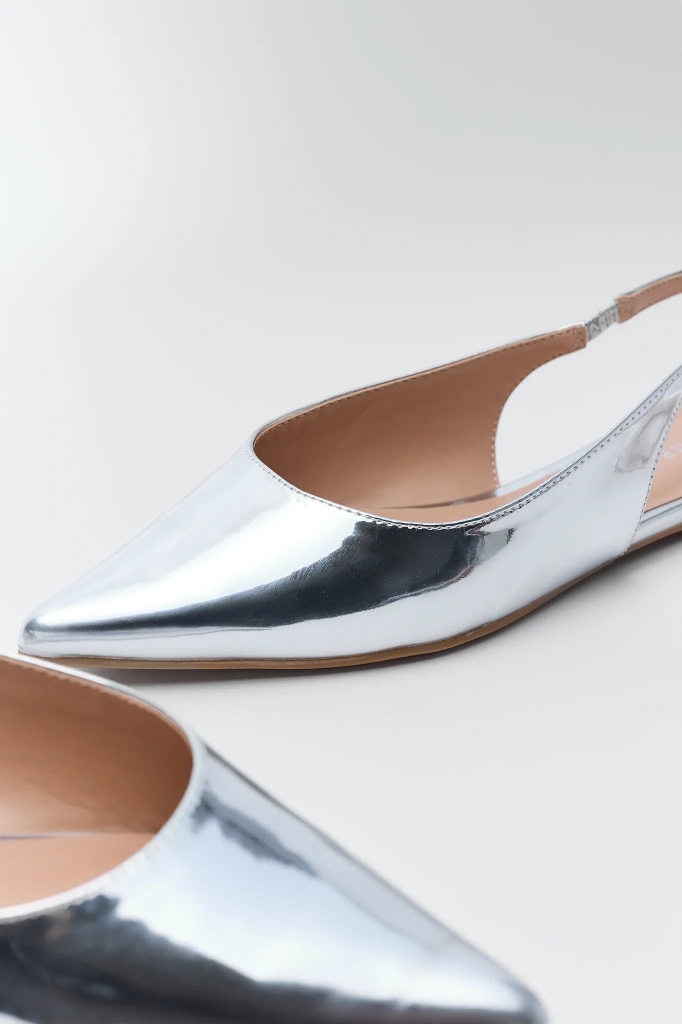 Sylvia Silver Metallic Flats on a white background