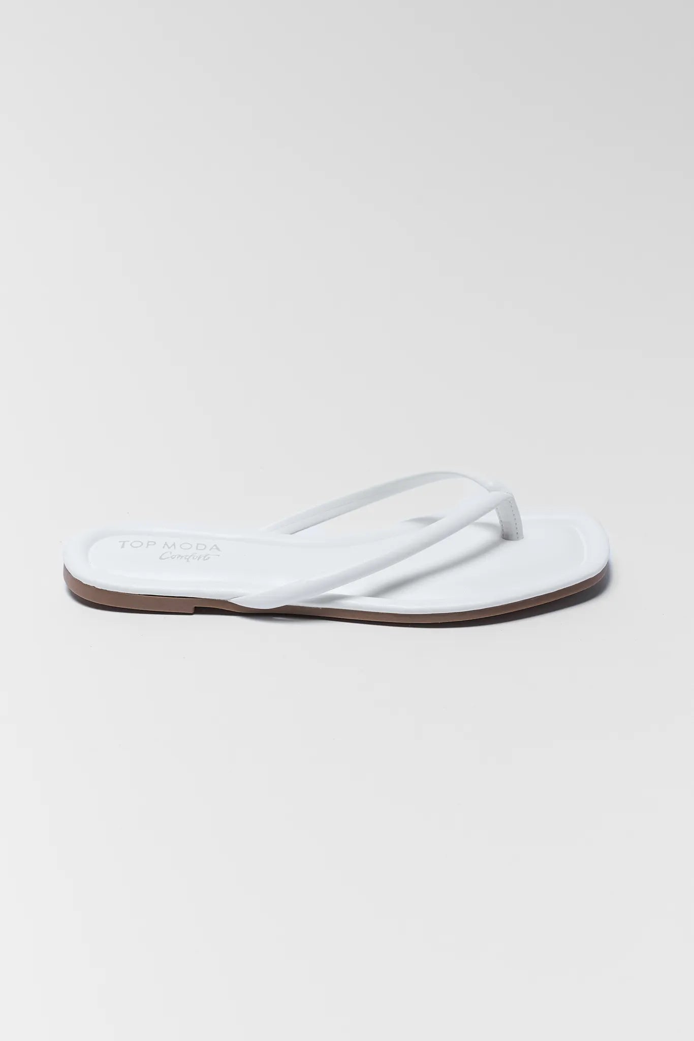 White sandal on a light gray background