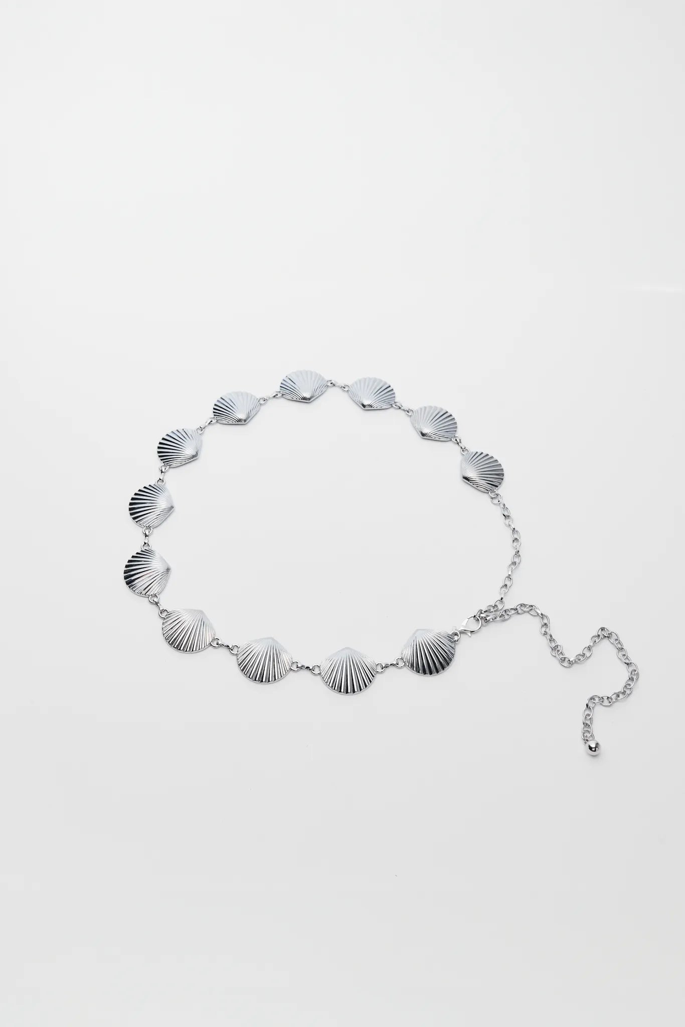 Silver shell belt on a white background