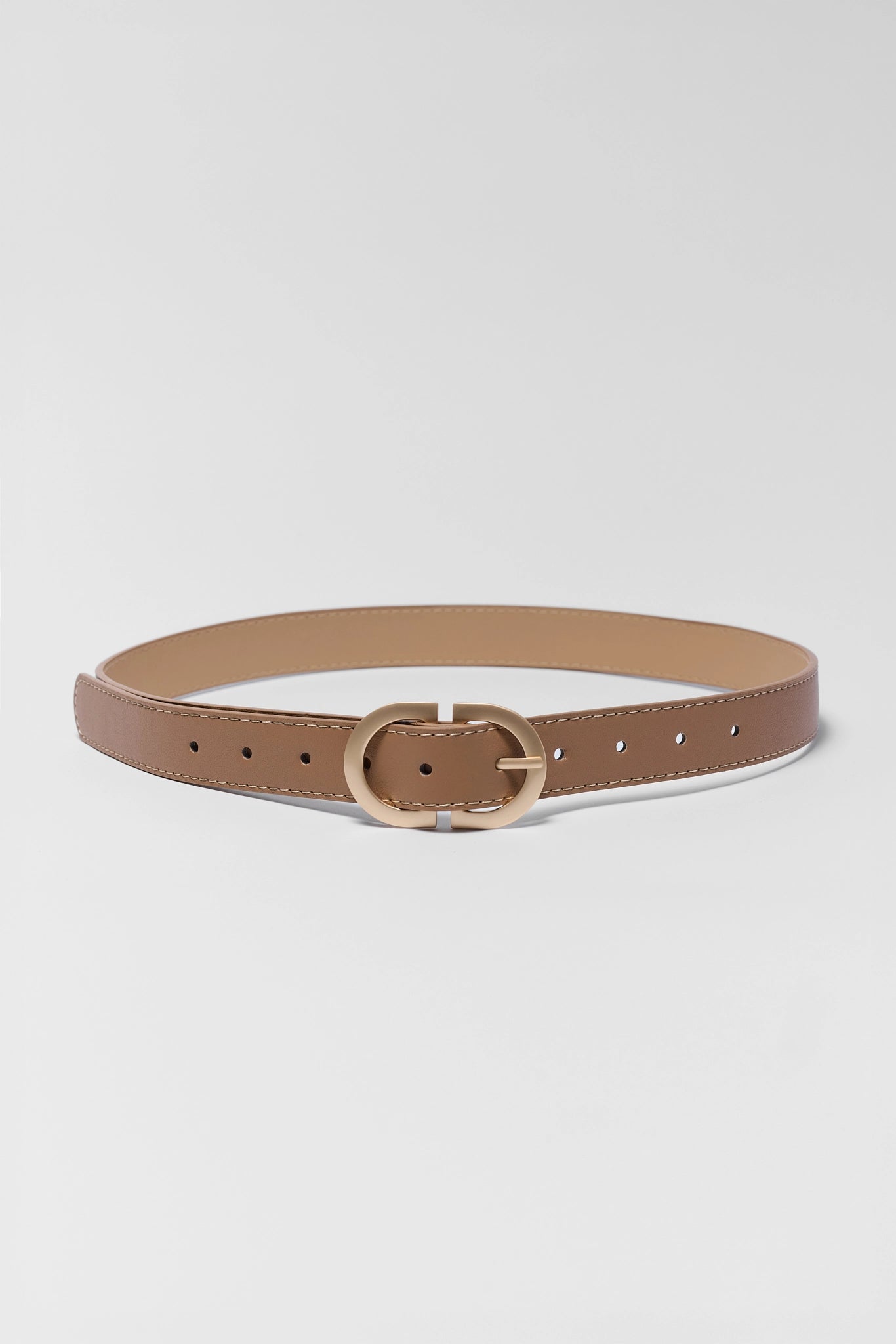 Brown belt with a gold buckle on a light gray background