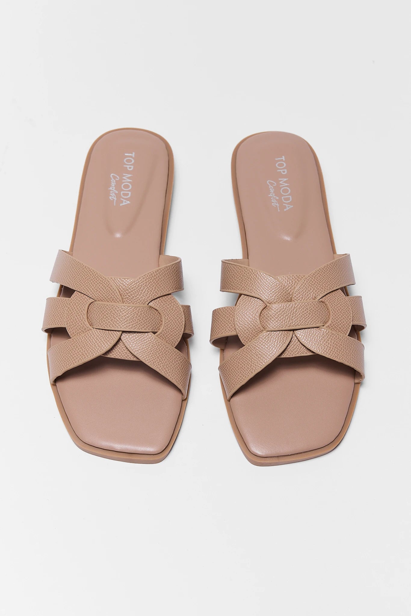 Pair of beige sandals with a woven design on a white background two tan slip on sandals