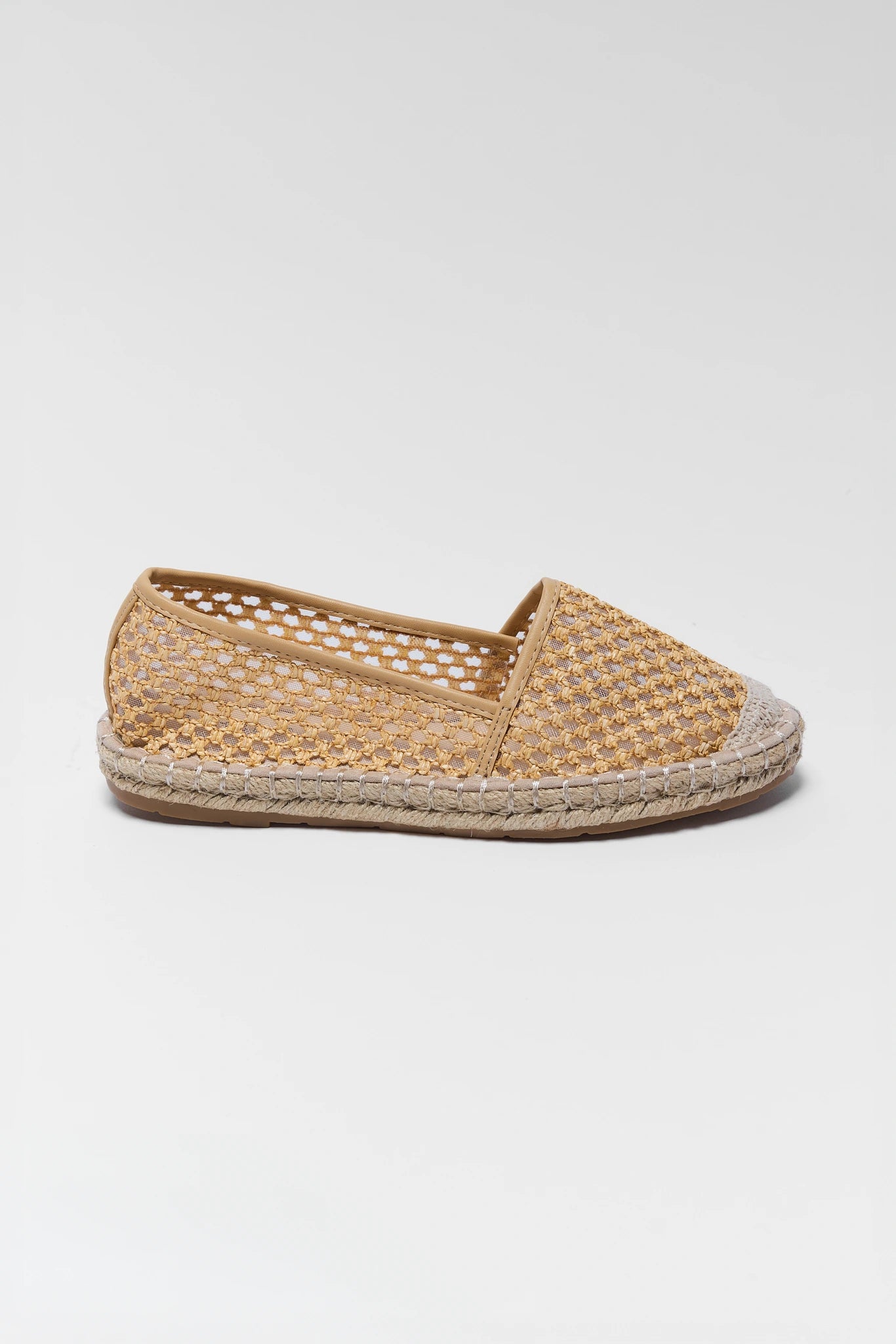 Woven espadrille shoe on a light gray background one