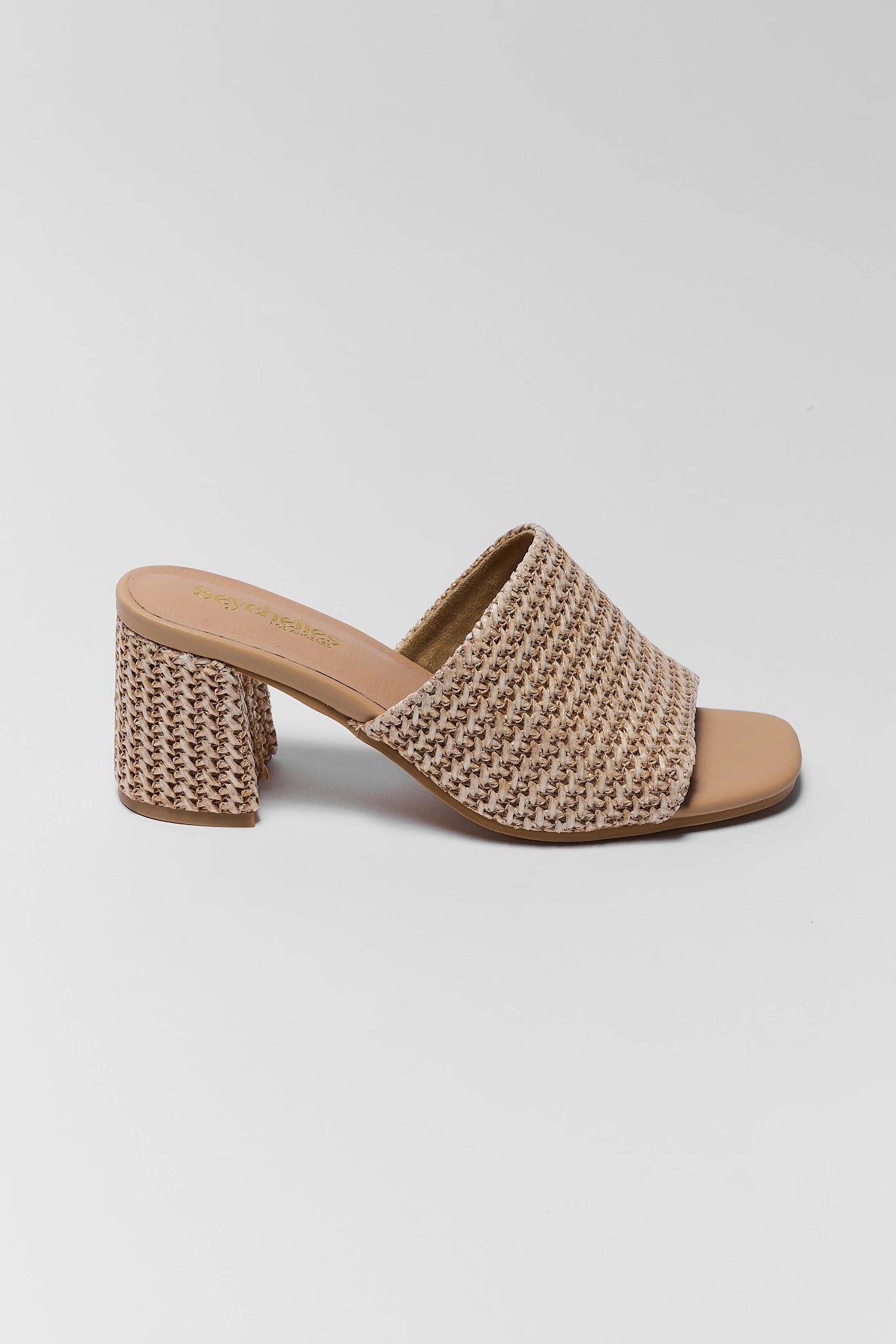 Beige woven sandal with a block heel on a light gray background one