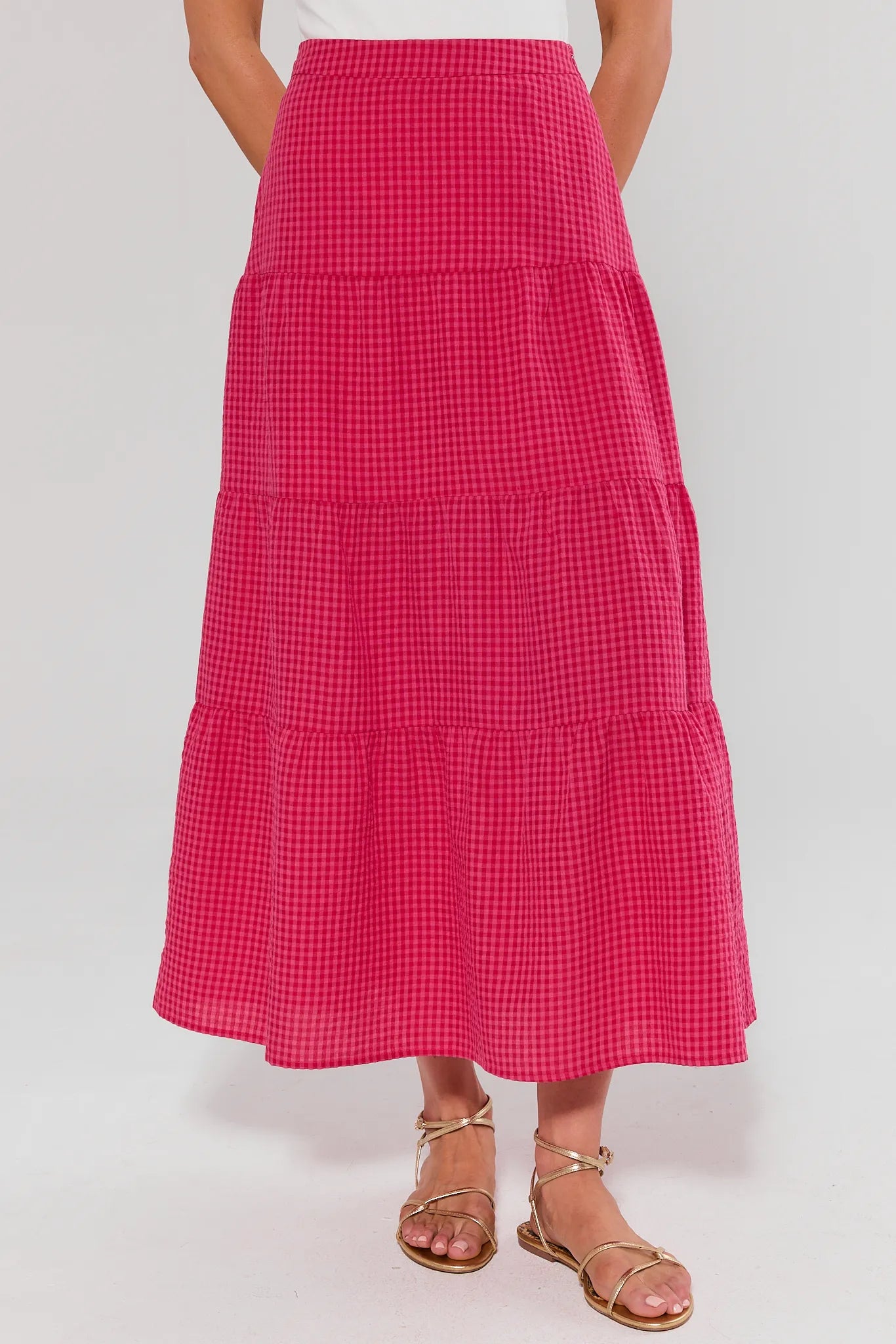 Red checkered skirt worn by a person on a white background
