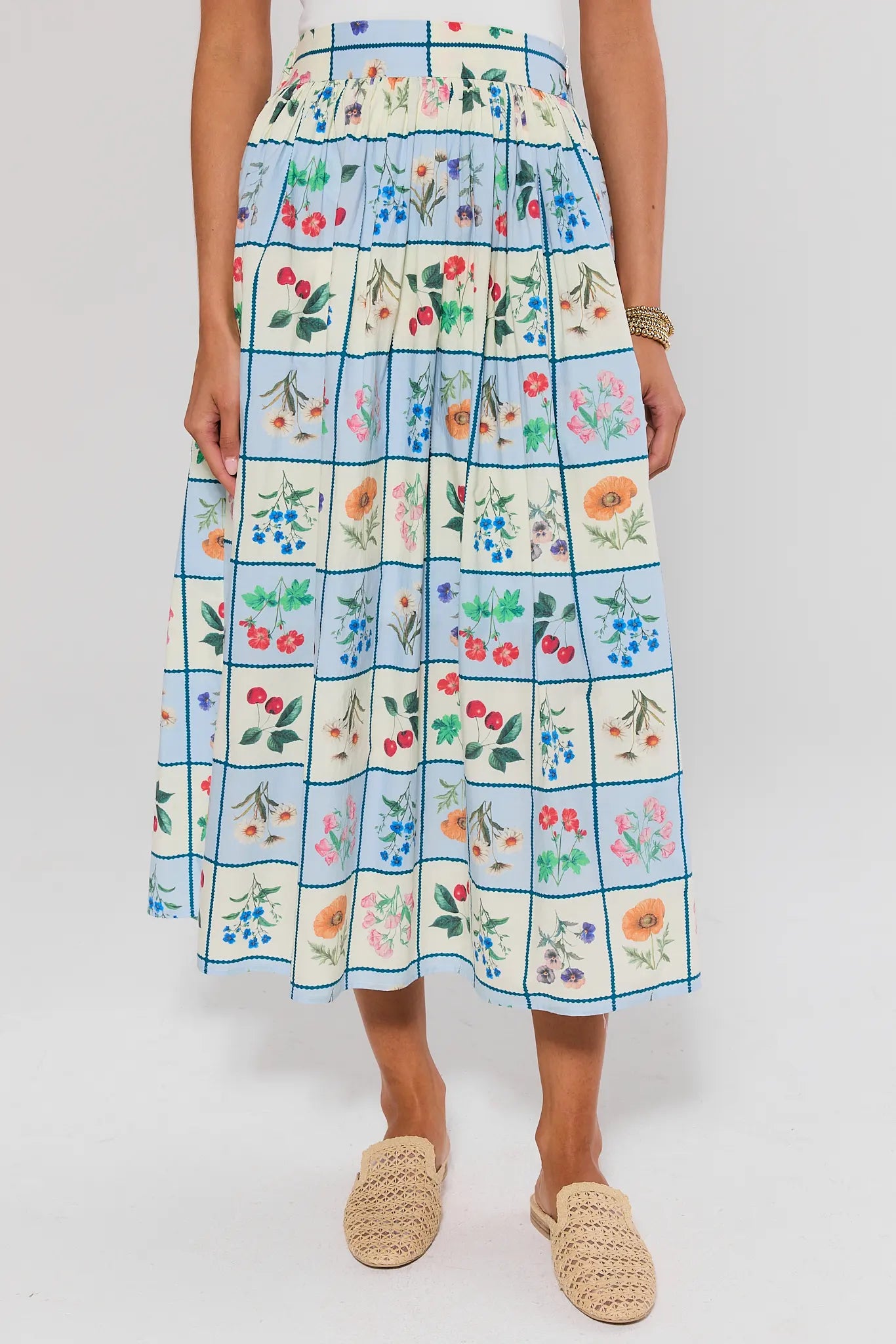 Person wearing a floral checkered skirt on a white background