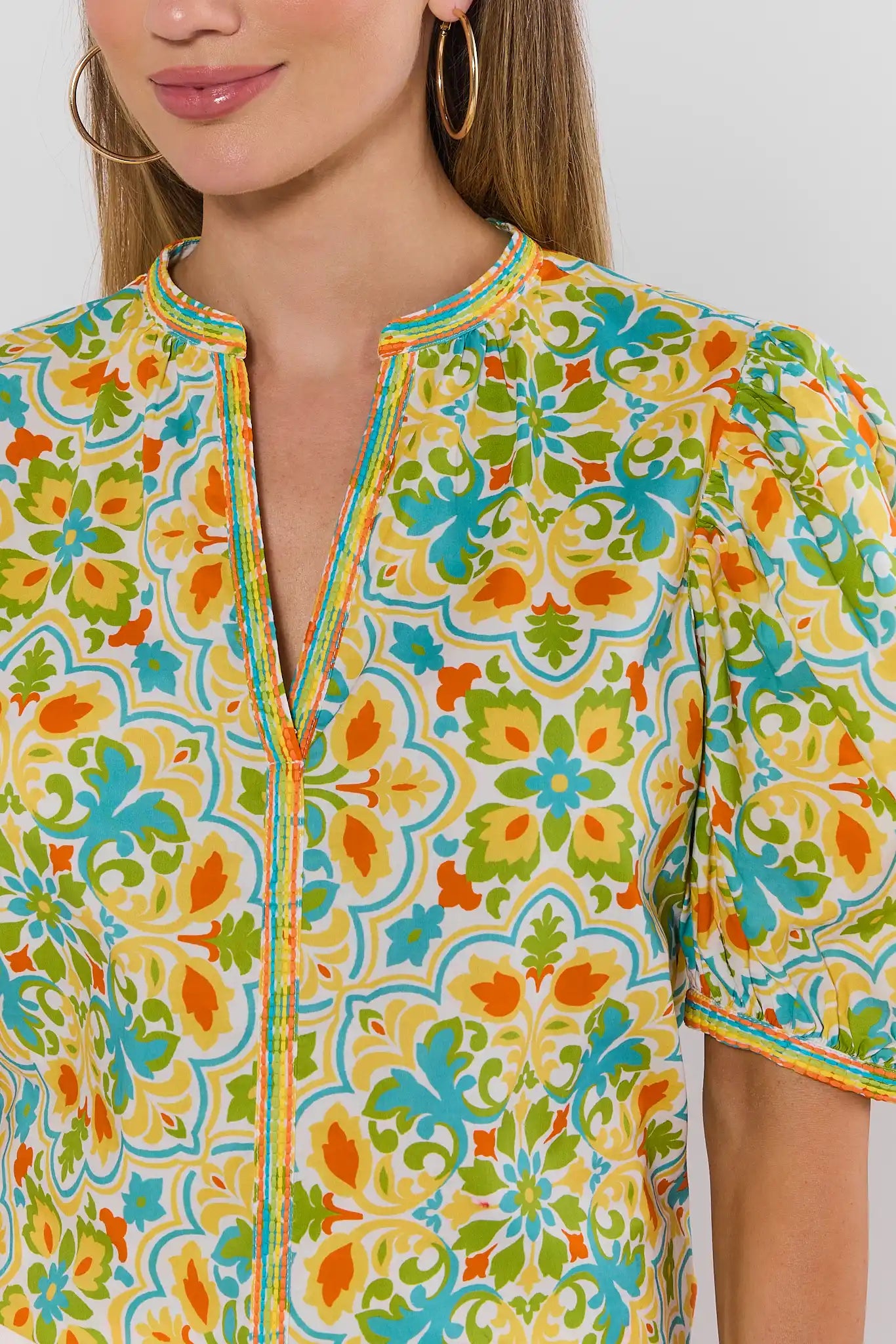 close up Colorful patterned shirt worn by a person on a plain background