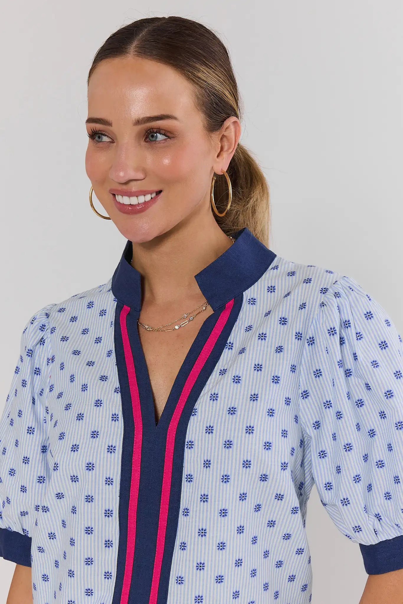 close up Woman wearing a patterned blouse with a white background