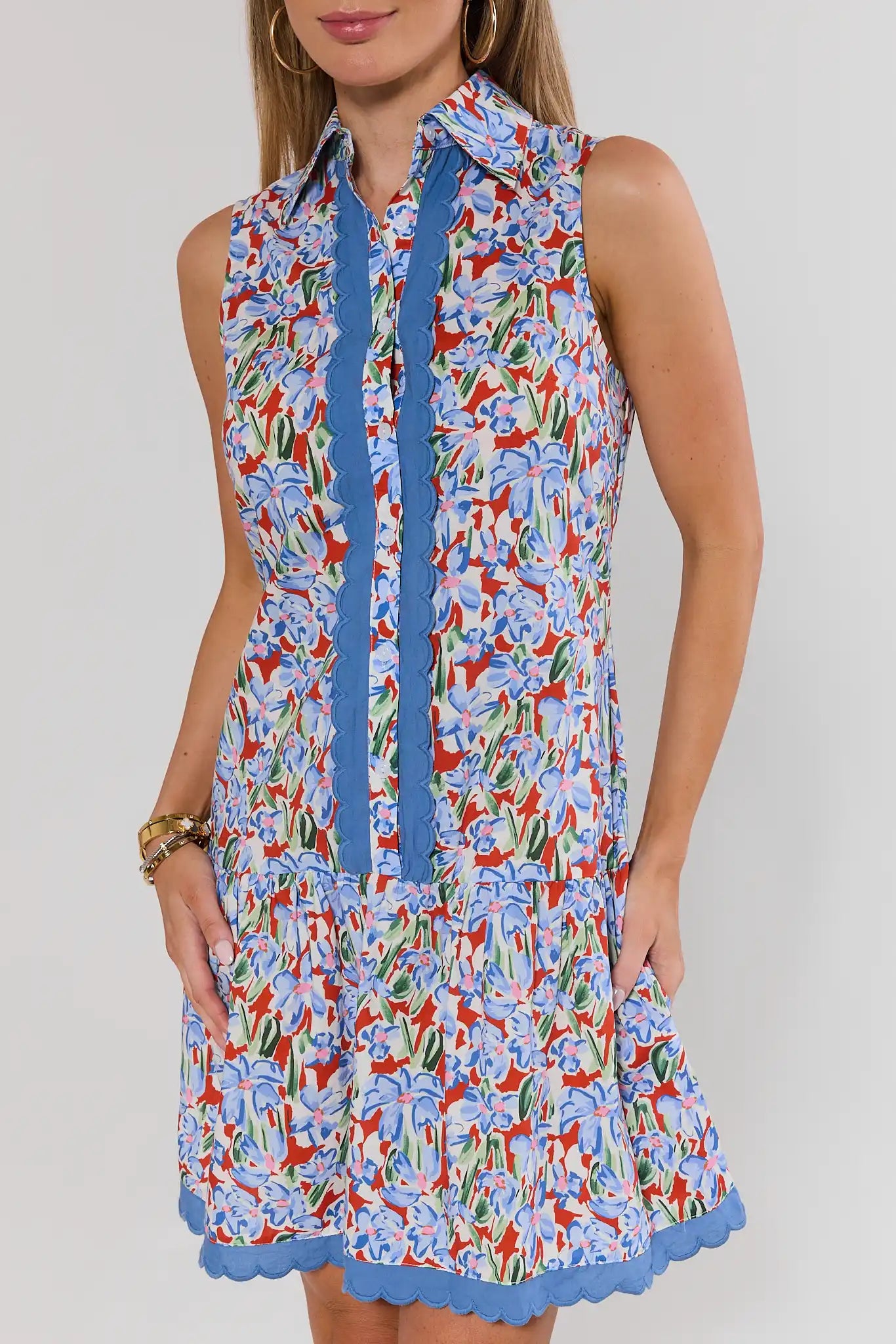 close up Woman wearing a colorful floral dress with a blue zipper on a white background