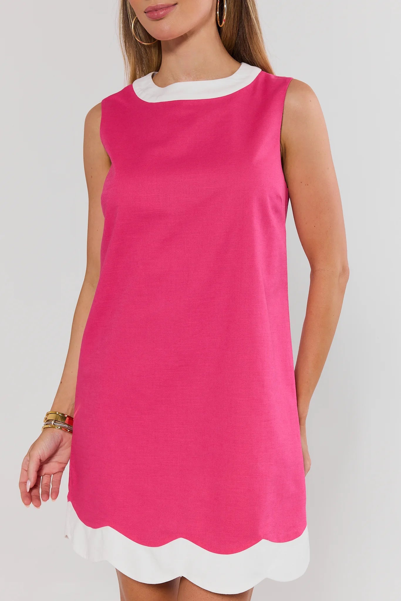 close up Pink dress with white trim on a plain background