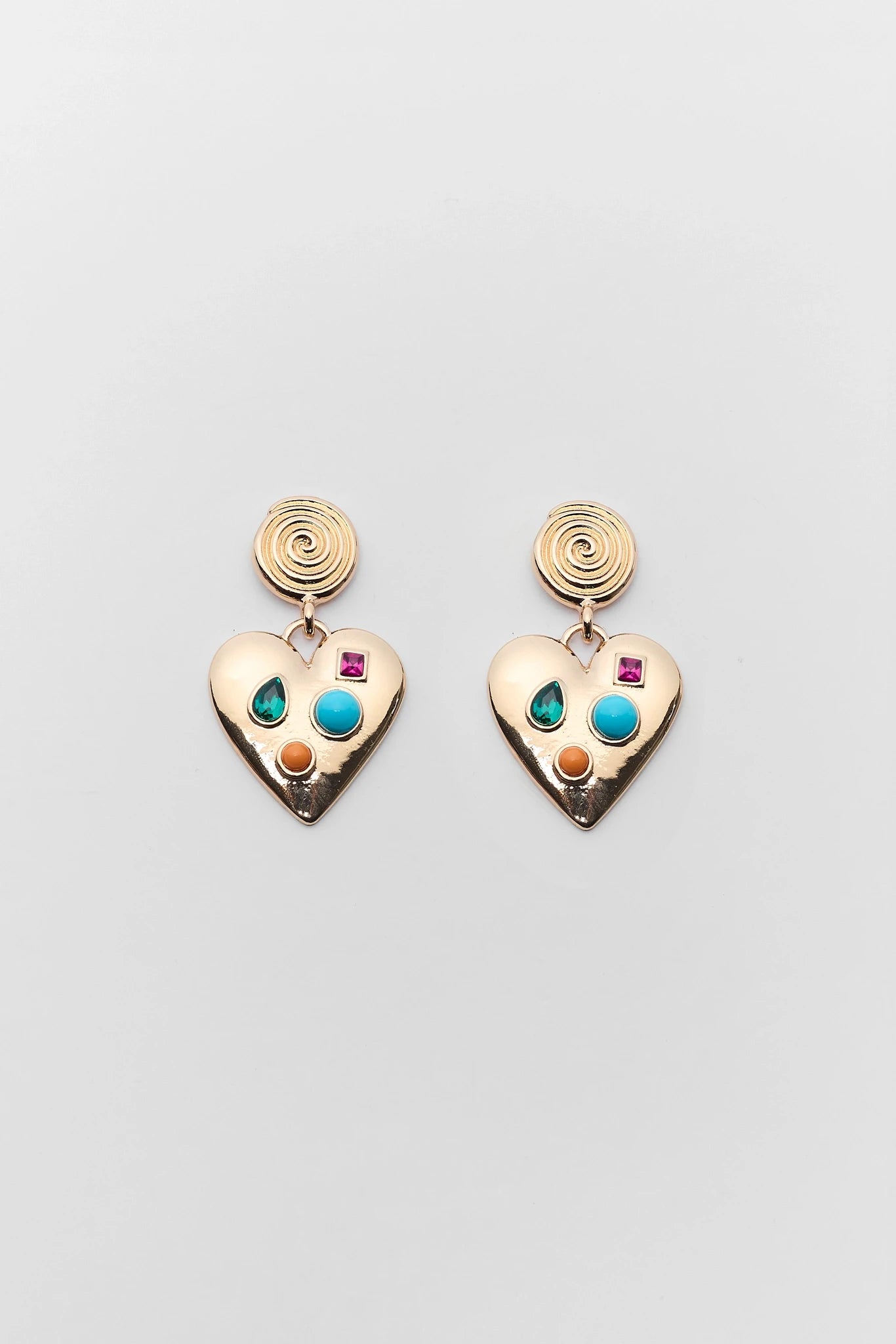 Heart-shaped earrings with colorful gemstones on a light gray background