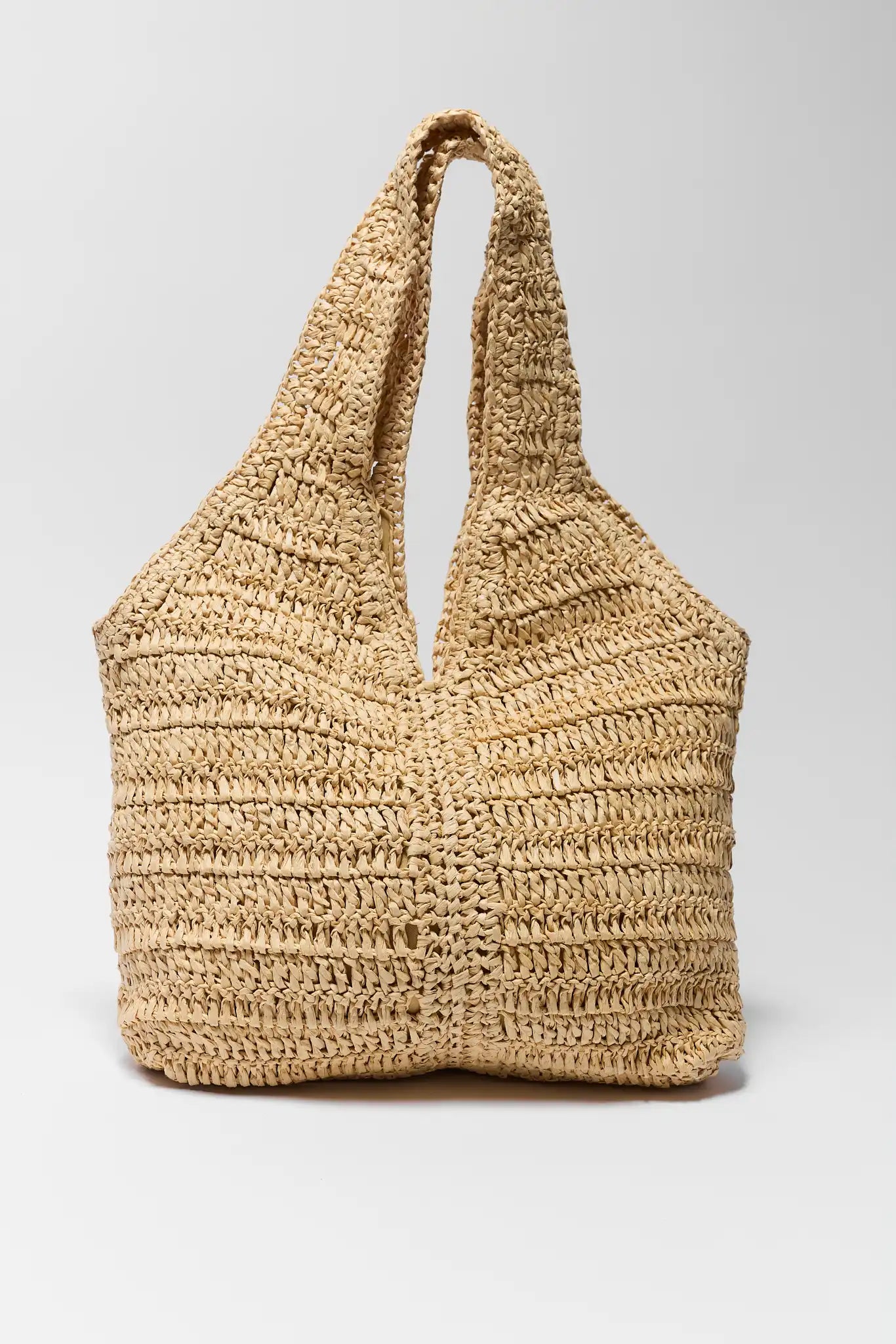 Woven straw bag on a light gray background