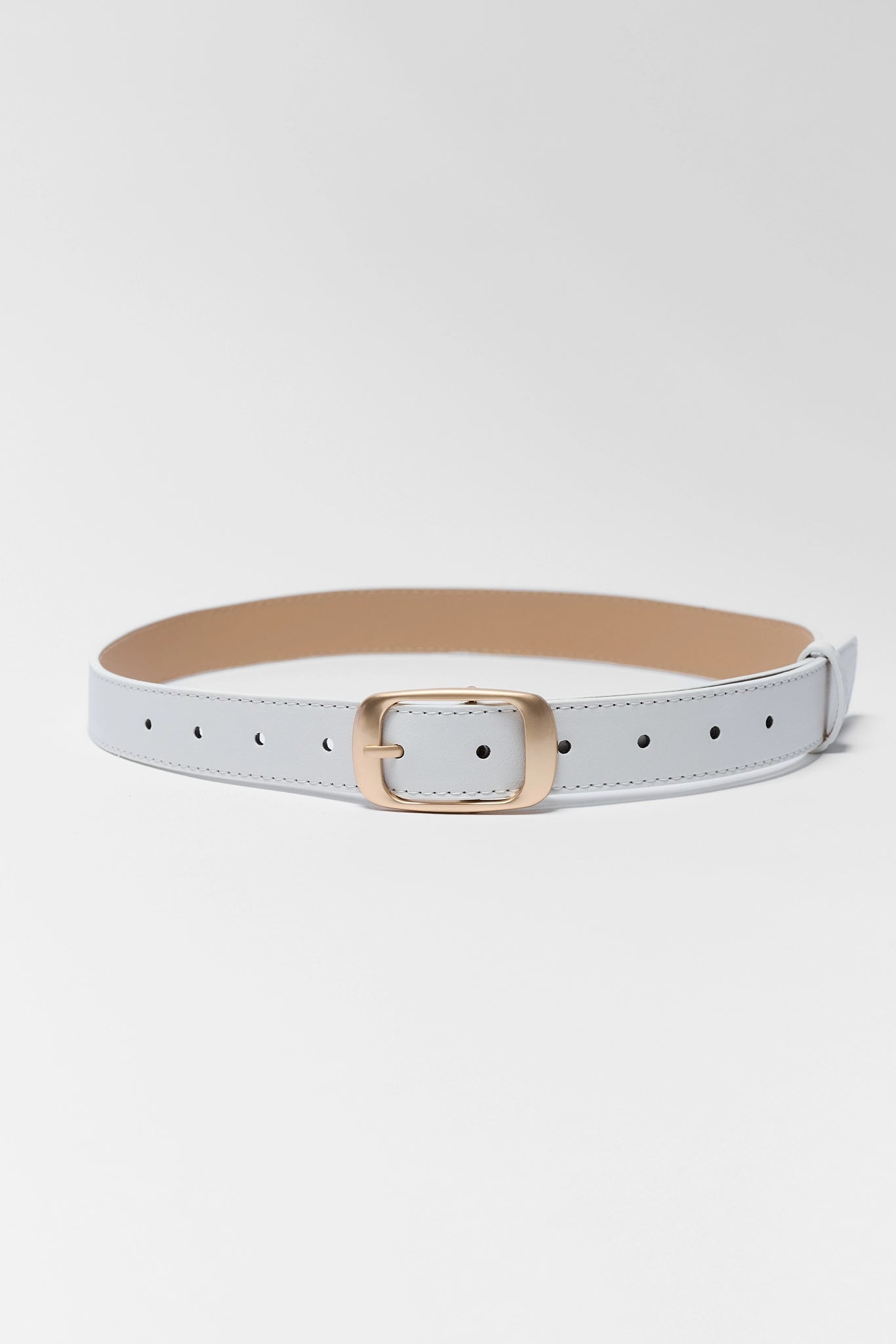 White belt with a gold buckle on a white background close 