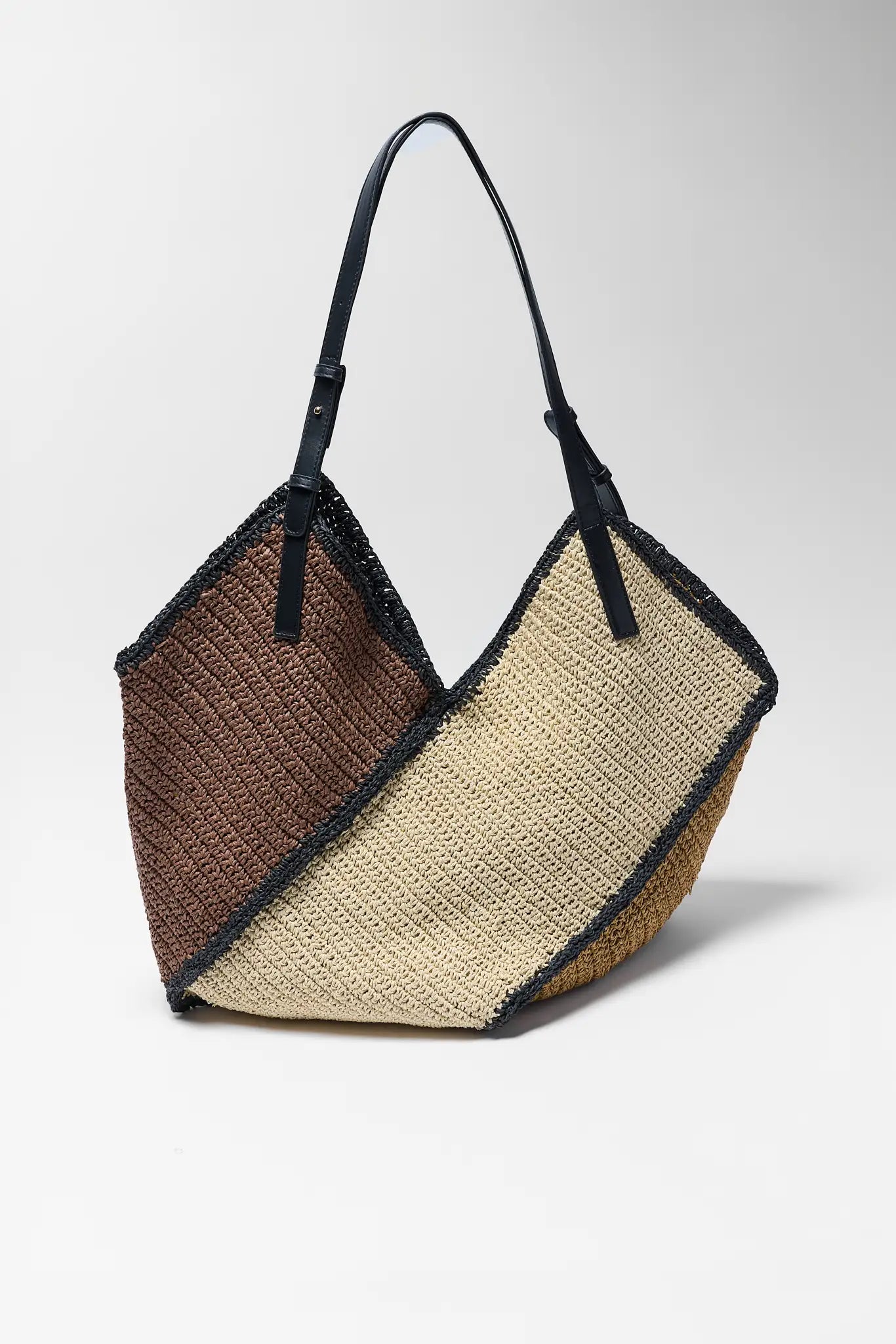 Woven handbag with two-tone design on a white background