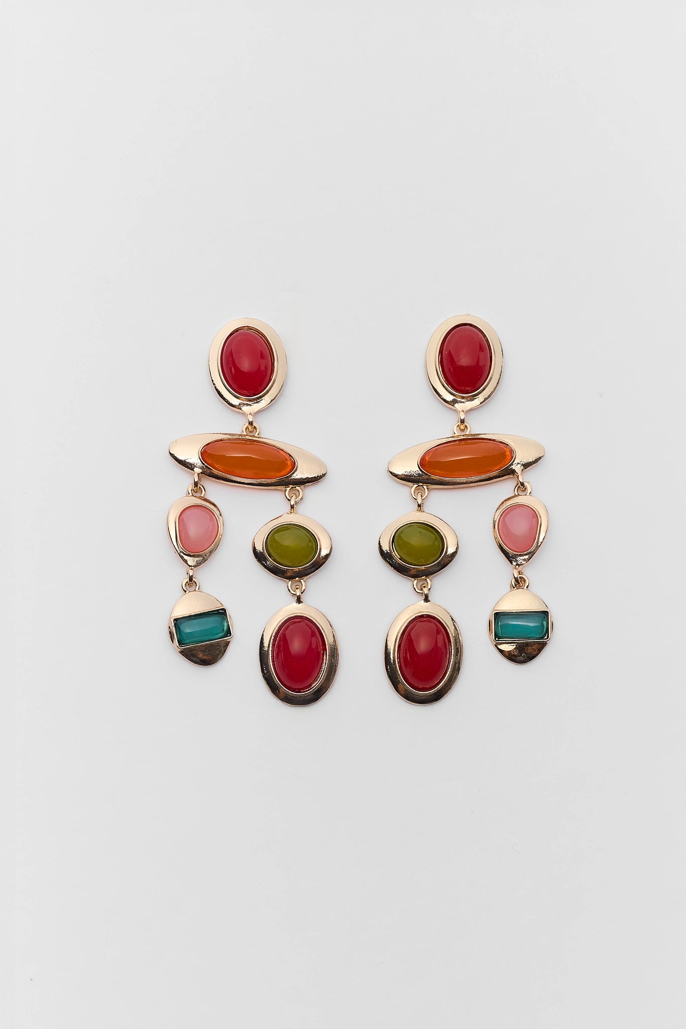 Colorful earrings with multiple gemstones on a light gray background