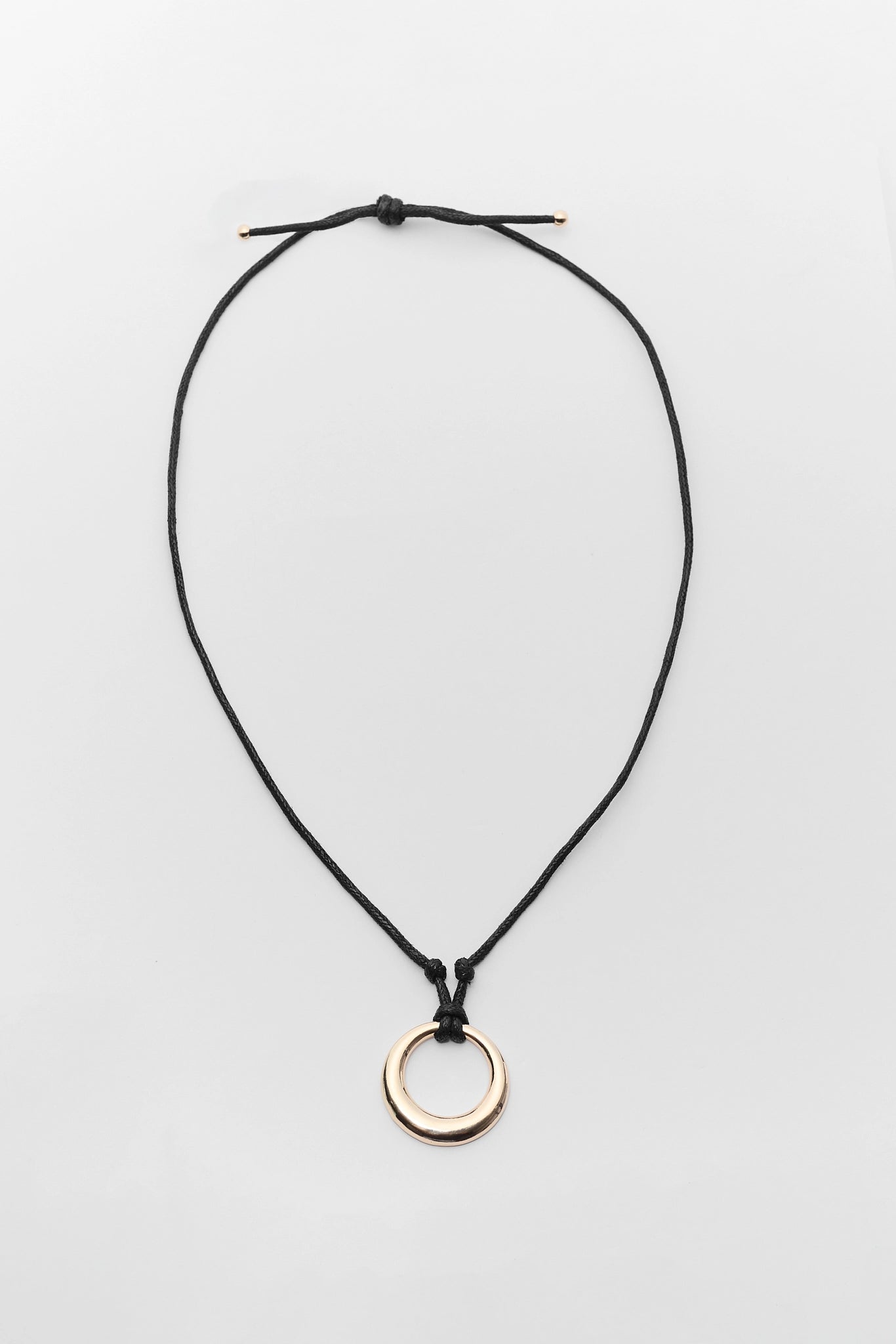 Necklace with a gold ring pendant on a white background