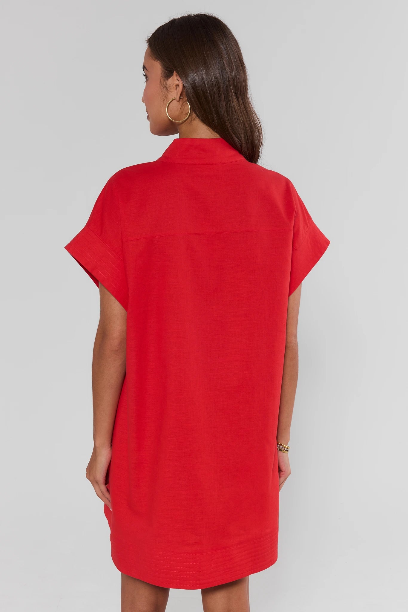 Red dress worn by a person on a plain background walking