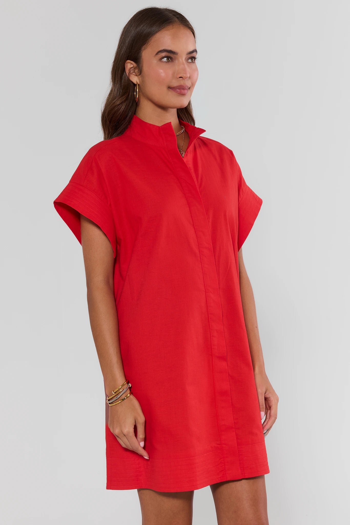 Woman wearing a red dress against a white background side