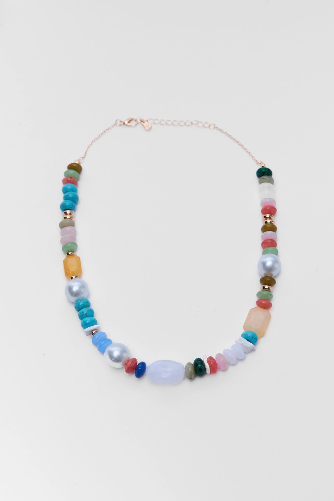 Colorful beaded necklace on a light gray background