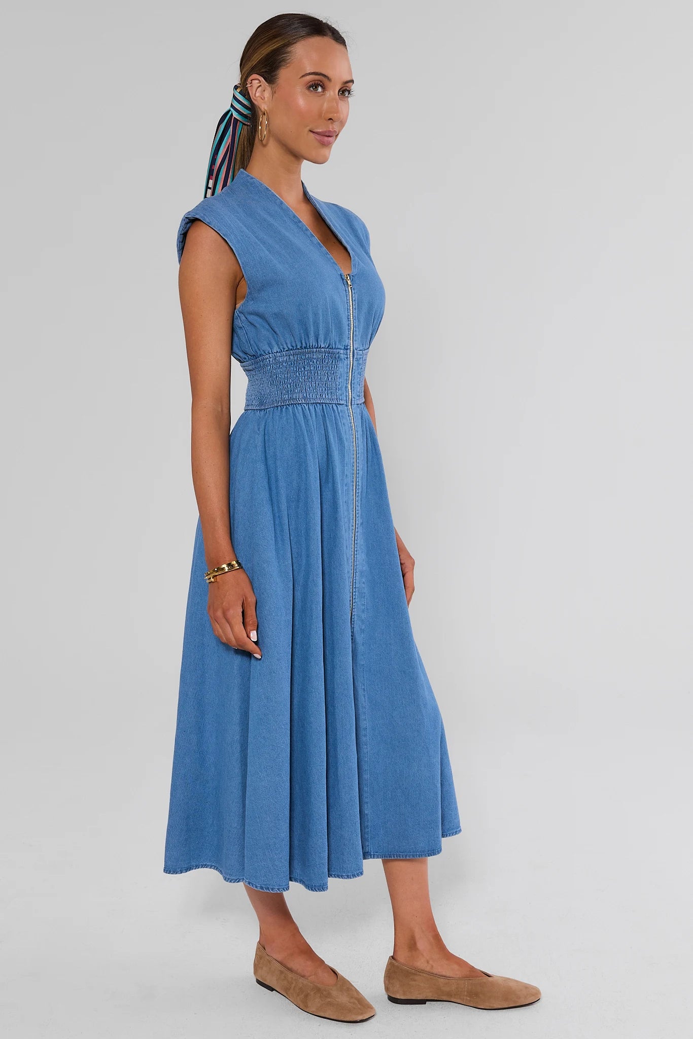 walking woman wearing collins medium wash dress on white background