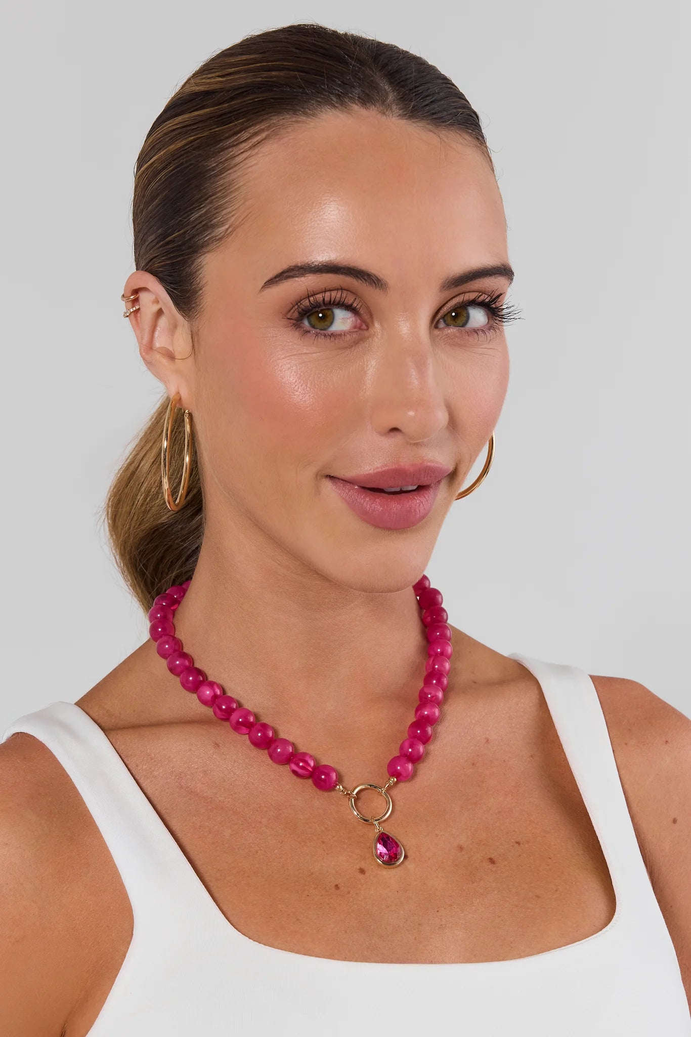 Woman wearing Pink Stone Drop Necklace on a white background