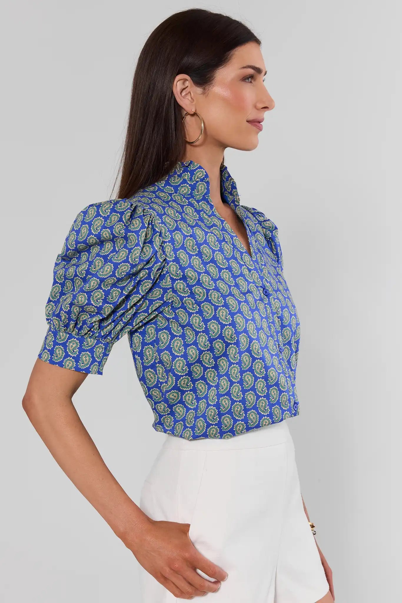 Woman standing to the side wearing Gracie Navy Paisley Print Top on white background