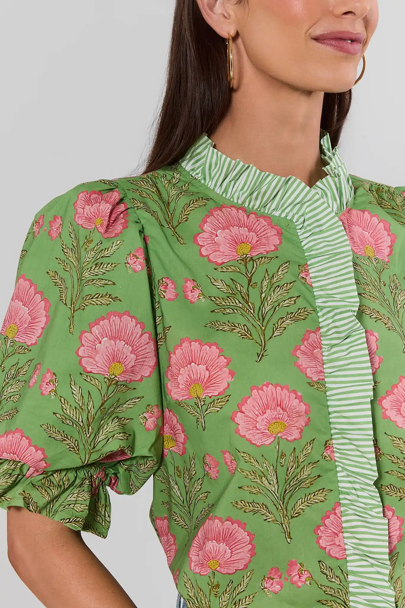 close up Woman wearing Green Floral Print Contrast Trim Top with jeans on a white background