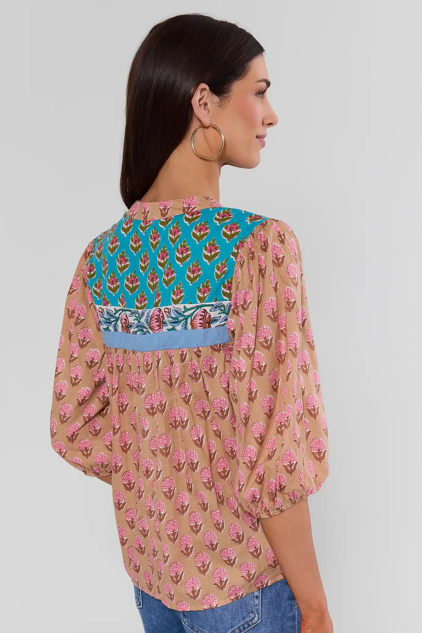 Woman wearing Multi Printed Split Neck Top by THML on a white background turned
