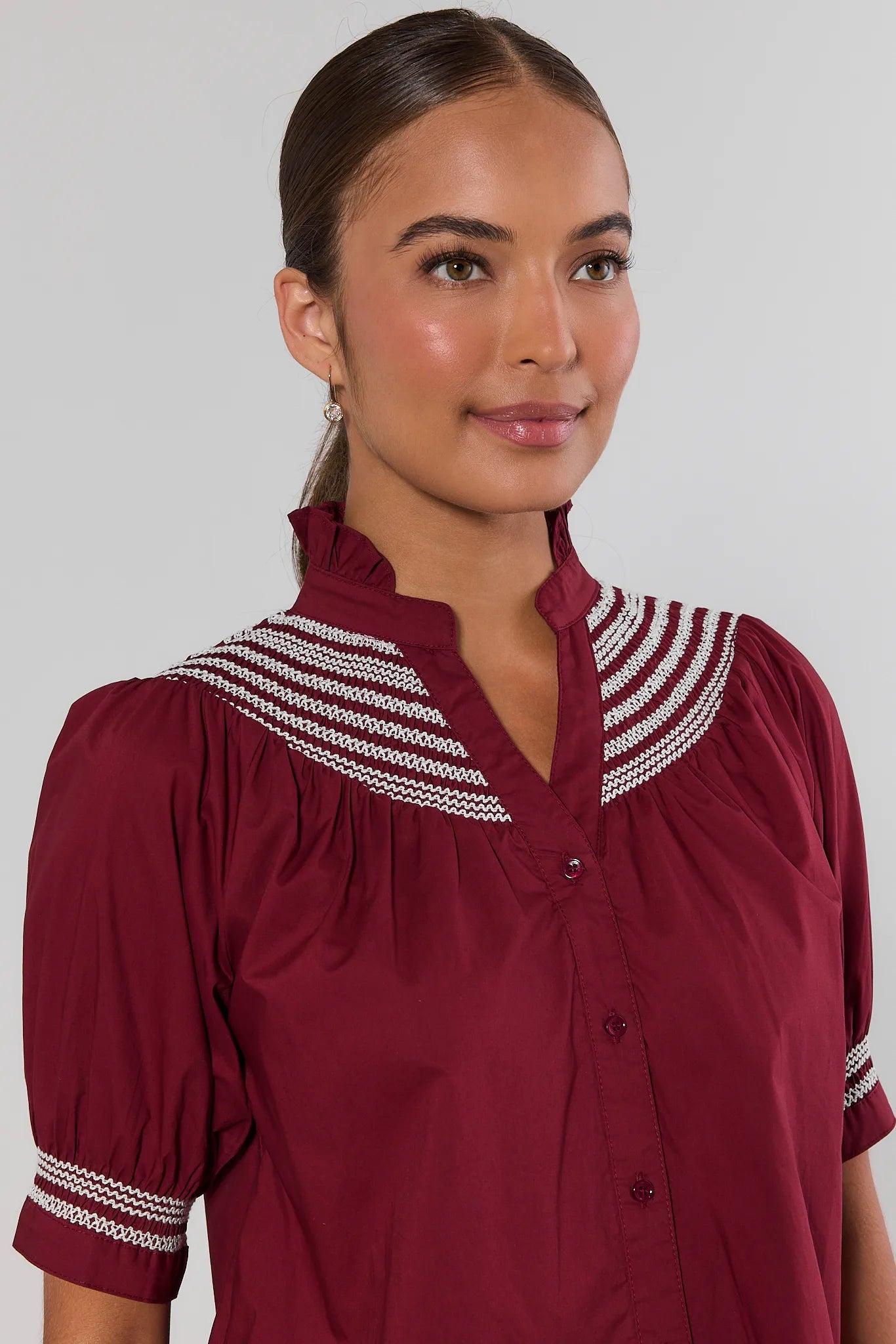 close up Woman wearing Yvonne Burgundy and White Embroidered Top on a white background