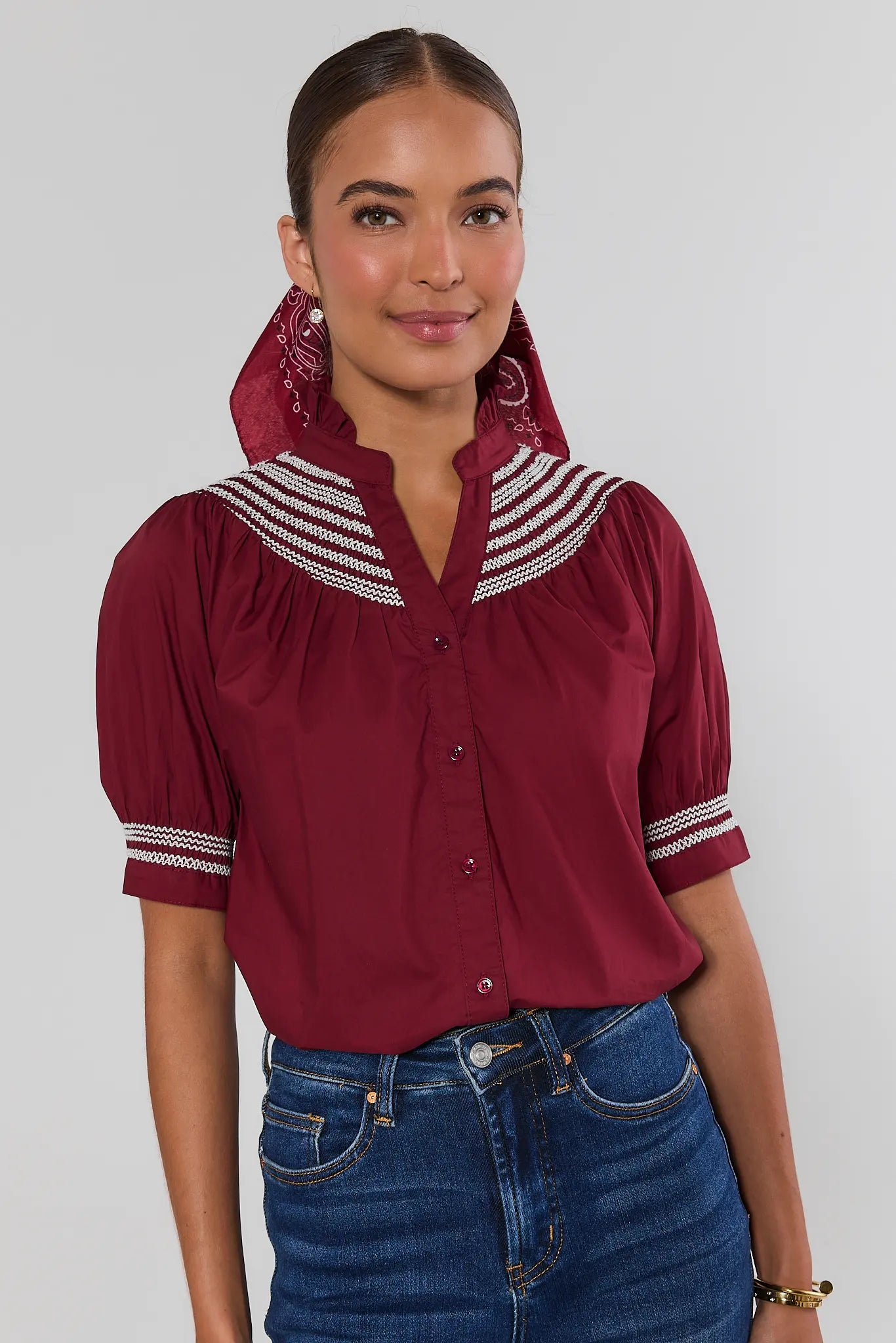 Woman wearing Yvonne Burgundy and White Embroidered Top on a white background