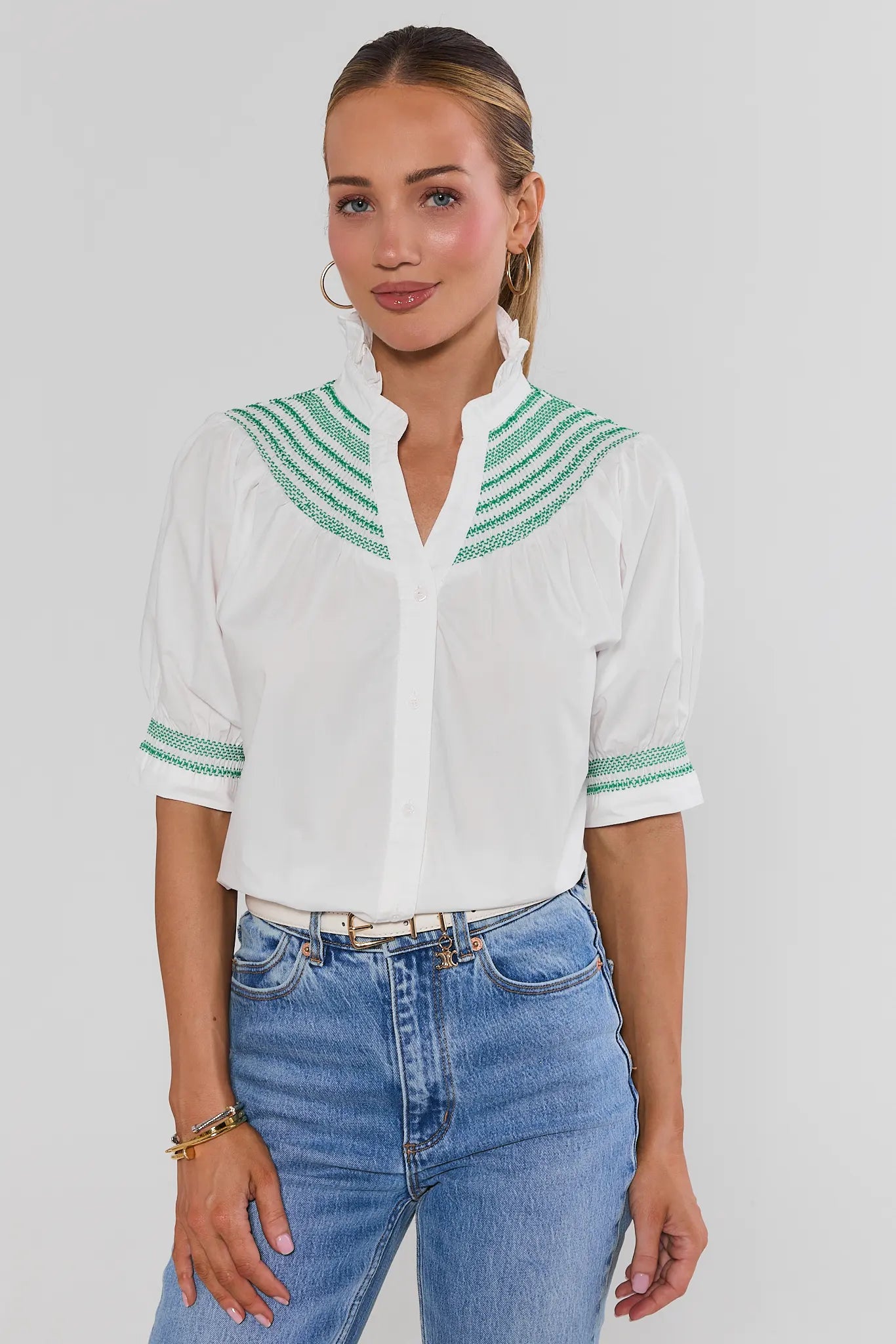 Woman wearing Yvonne White and Green Embroidered Top on a white background