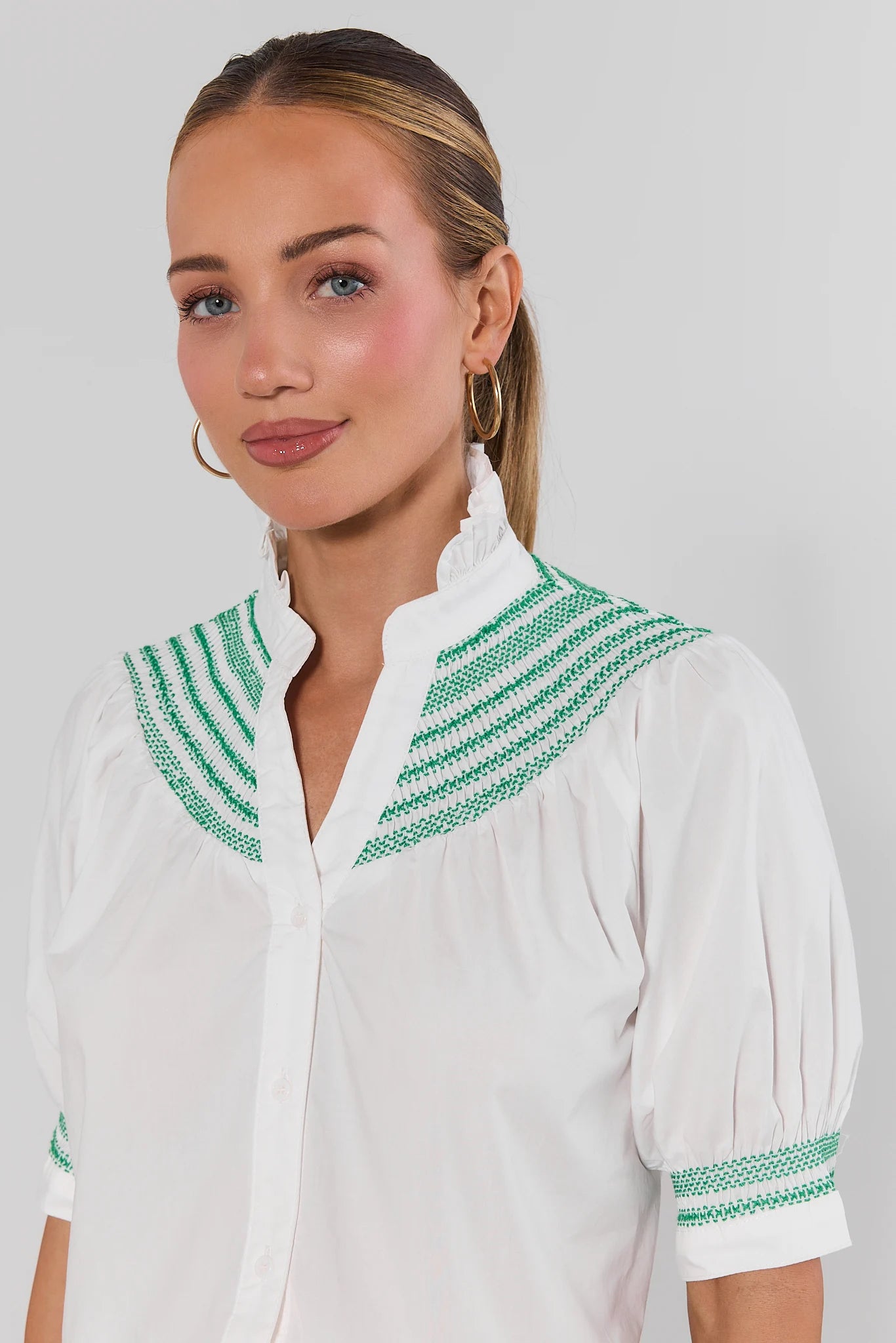 close up Woman wearing Yvonne White and Green Embroidered Top on a white background