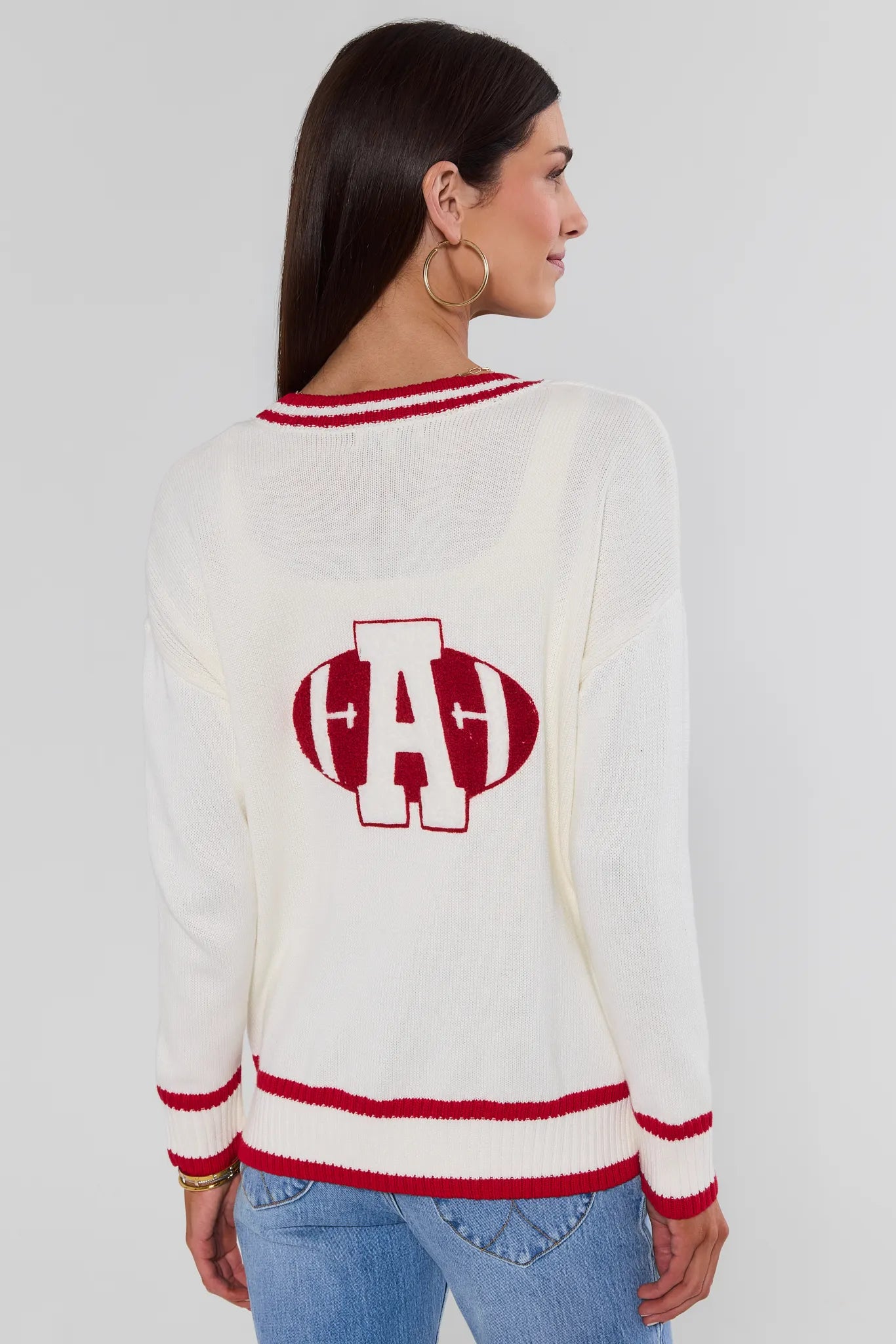 Woman wearing Jenna Ivory Applique Cardigan with A football logo on the back