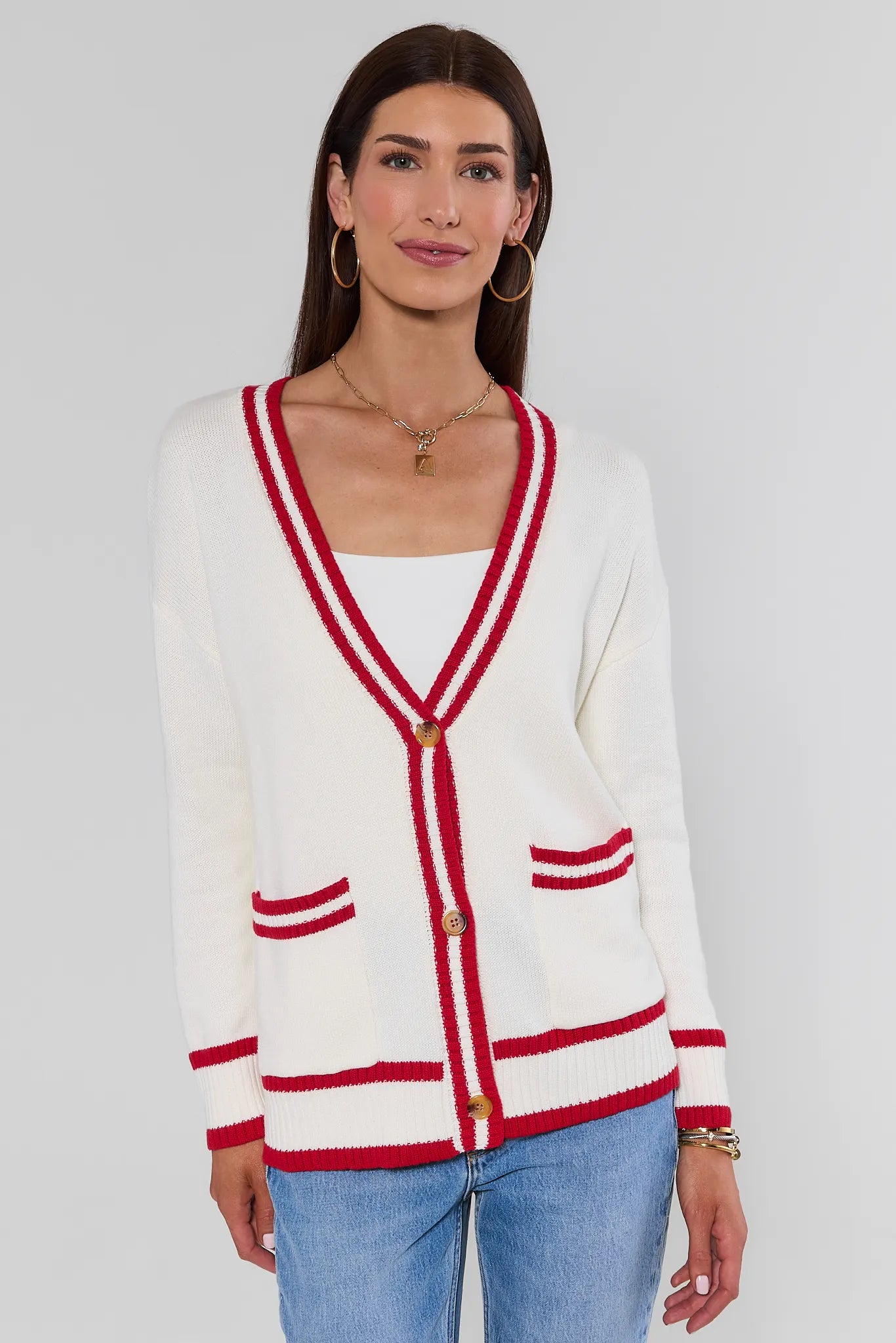 woman wearing Jenna Ivory Applique Cardigan on a white background standing