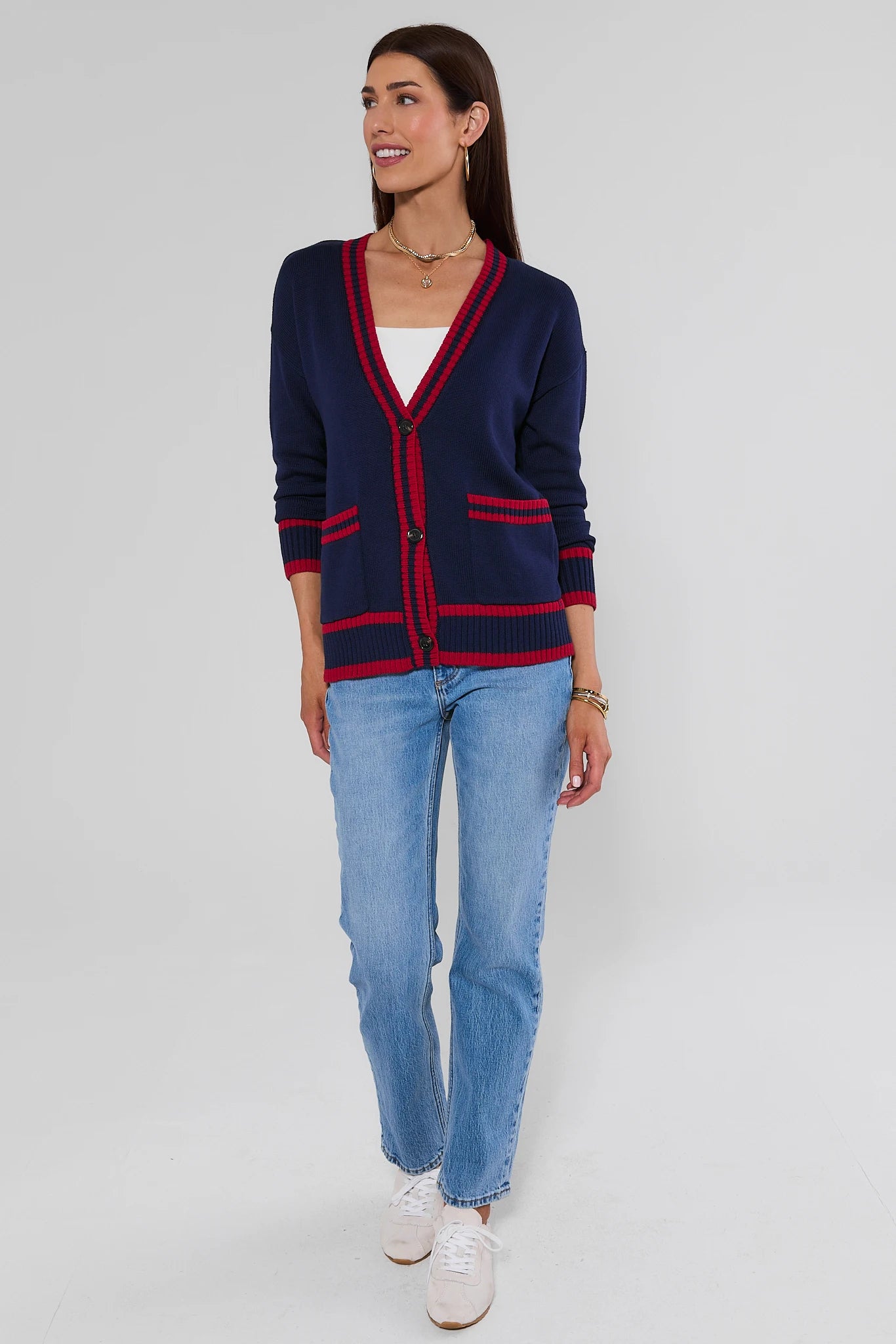 Woman walking wearing Navy Contrast Trim Applique Cardigan on a white background