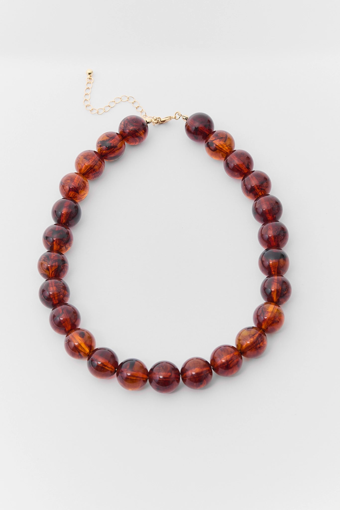 Amber Brown Beaded Statement Necklace - Flat Lay with Gold Clasp | Avara
