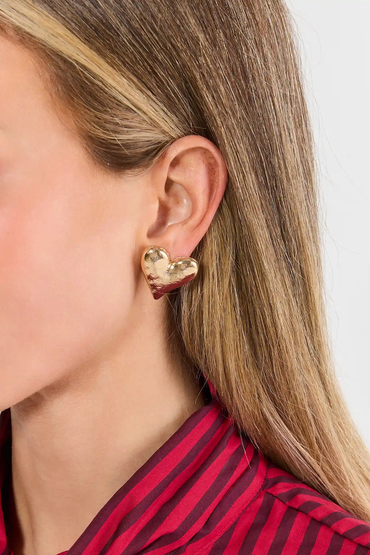 Gold Heart Stud Earrings - Close-Up On Model, Side Profile | Avara