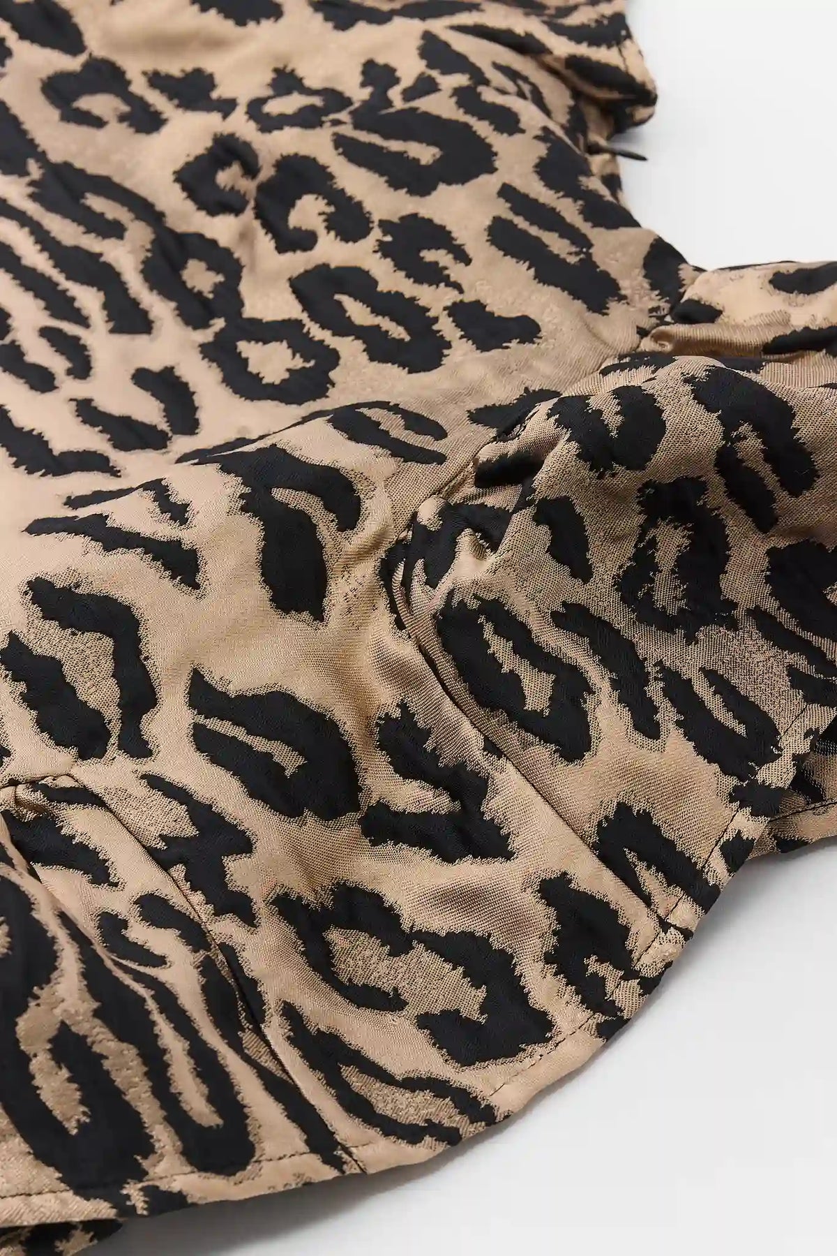 Tan Leopard Print Peplum Hem Flat Lay Detail - Animal Print Top | Avara