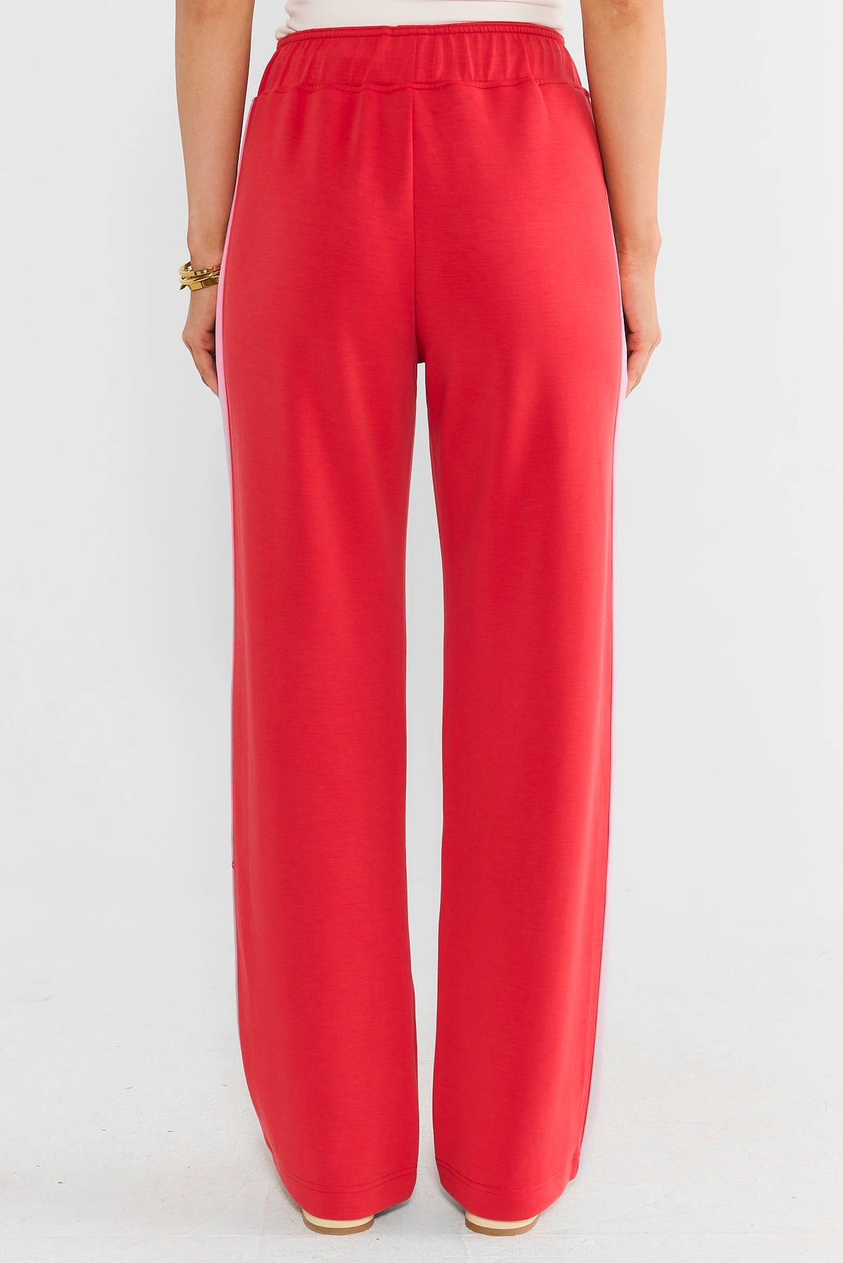 Red Relaxed Lounge Pants with Pink Side Stripe - Back View On Model | Avara