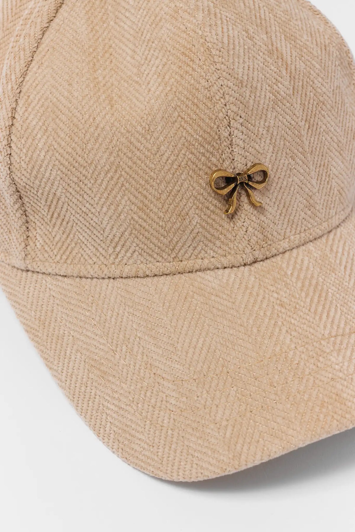 Tan Textured Baseball Hat - Gold Bow Hardware Close-Up Detail | Avara