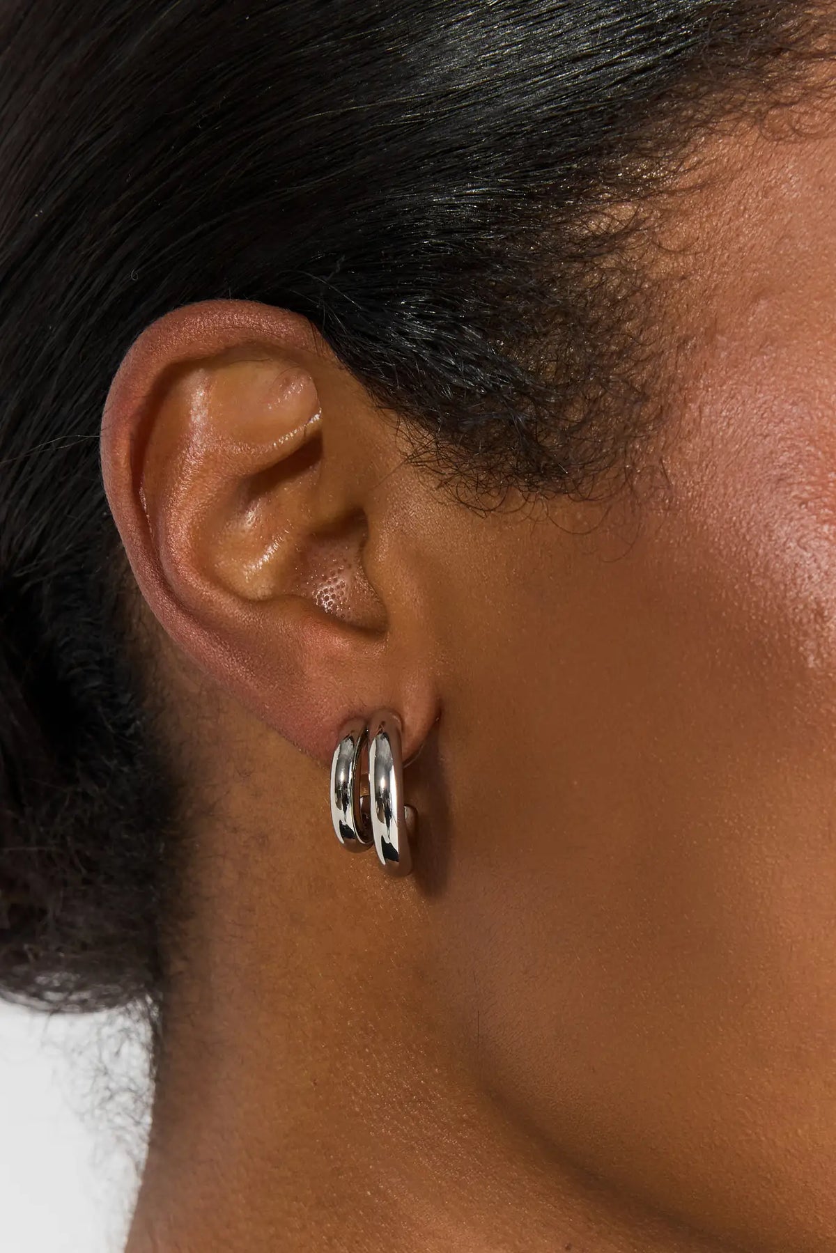 Silver Chunky Double Hoop Earrings - Close-Up Ear Detail on Model | Avara