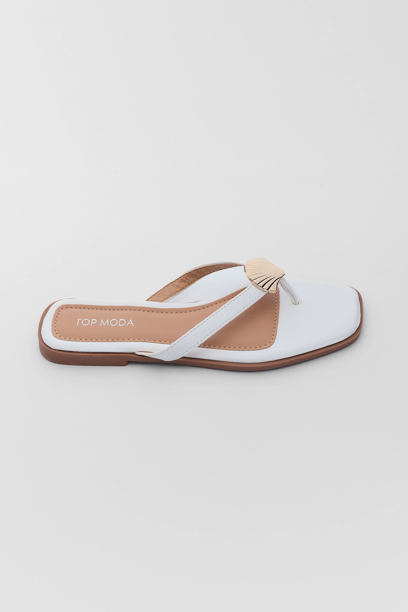 one White sandal with a brown sole on a light gray background