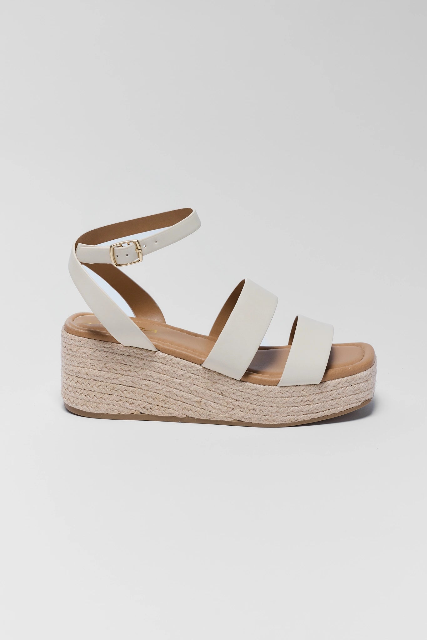 White sandal with wooden sole on a light gray background